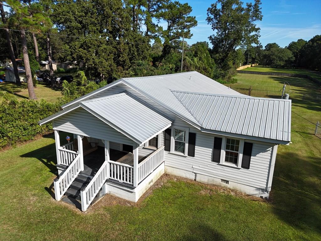 You have to see this charmingly rustic home in Thomasville, GA! This 3BR/3 bath home has tons of open living space, a wonderful living room, formal dining room and cute kitchen. The original hardwood floors give the home a rural feel, even though you are close to everything in town. Home also features a glorious sunroom/multi-purpose room, with beautiful panel walls and ceiling. And you will love your quiet time on the cute front porch. All this sits on a MASSIVE 1+acre yard with fencing, a spot for a firepit, and storage building. Call your favorite agent TODAY for a closer look!