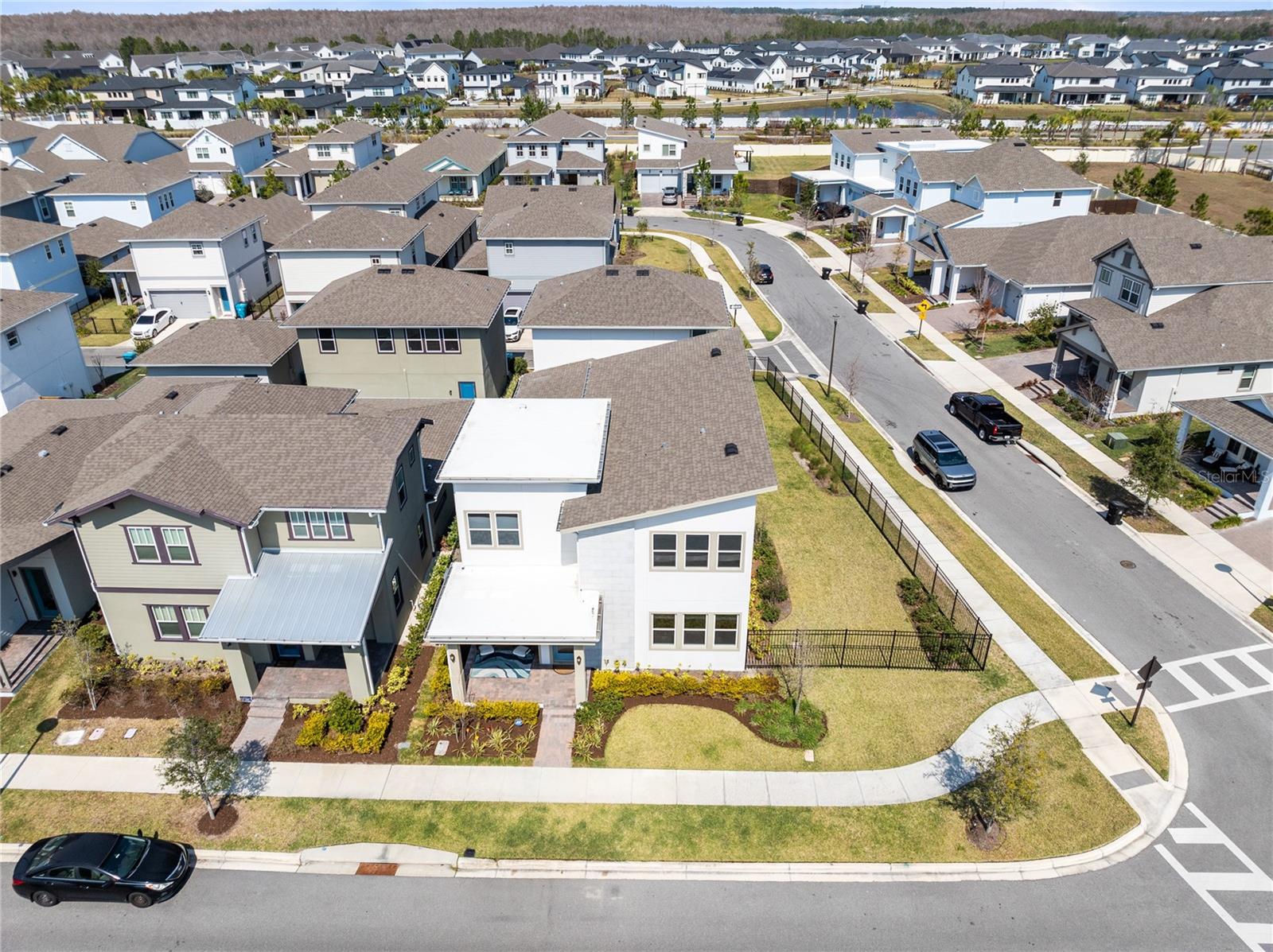 Located on a desirable corner lot in Laureate Park, this beautifully designed home offers flexible living, modern finishes, and the added benefit of a detached garage apartment. The open concept main living area features abundant natural light, neutral finishes, and seamless flow between the living room, dining space, and kitchen, creating an inviting environment perfect for both everyday living and entertaining.The first floor primary suite provides a private retreat with a tray ceiling, generous space for a sitting area, and large windows that fill the room with natural light. The spa inspired bathroom features a dual sink vanity, modern cabinetry, and an oversized glass enclosed shower with stylish tile finishes and a luxurious rain shower head. Two spacious walk in closets provide excellent storage and organization.Upstairs, a large loft offers flexible living space that can serve as a media room, playroom, or home office. The second floor also features three additional bedrooms. Two of the bedrooms share a convenient Jack and Jill bathroom, while the third bedroom includes its own private ensuite bath, creating comfortable accommodations for family members and guests.Outdoor living is equally impressive with a spacious covered lanai that creates a private courtyard style setting between the main home and the detached garage apartment. This outdoor space is perfect for entertaining, offering room for both dining and lounge seating while maintaining a comfortable shaded area for relaxing or hosting guests.The detached garage apartment adds incredible versatility and value to the property. This private one bedroom apartment features a full kitchen with stainless steel appliances, a separate living room, dining area, private bedroom, full bathroom, and its own laundry. Whether used for rental income, extended family, or a private guest suite, the apartment offers flexibility that is highly sought after in Laureate Park.Laureate Park isn’t just a neighborhood it’s a vibrant lifestyle. Enjoy the Aquatic Center, resort style pools, LP Fit gym, and 44 plus miles of trails. Located in prime Lake Nona, minutes from Medical City, the VA hospital, Nemours, dining, and shopping. Close to major highways, Orlando International Airport, and the USTA National Campus. Easy access to Orlando’s top theme parks and beautiful Florida beaches. This home blends space, flexibility, and community in one of Lake Nona’s most sought after neighborhoods.