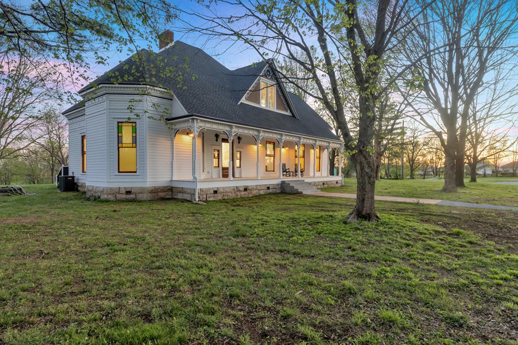 Drive up the tree-lined driveway to this stunning circa 1878 home, beautifully restored through a meticulous 3-year renovation. Situated on just under 12 acres, this 1 -of-a-kind property offers over 4,100 square feet of living space with 6–7 bedrooms, 4 full bathrooms, & 2 half baths—perfect for large families, entertaining, or multi-generational living.  Nearly every major component has been updated, including a new foundation, plumbing, electrical, roof, kitchen, & bathrooms—providing the peace of mind of modern construction while preserving its historic charm.  A master carpenter has carefully reworked the home's original character, including the wood baseboards, wood siding shingles, fireplaces, stained glass windows, & intricate woodwork—bringing timeless craftsmanship back to life. Enjoy the privacy & beauty of country living with open acreage & serene surroundings, all while being conveniently located near Fort Campbell/Night Stalkers Gate.