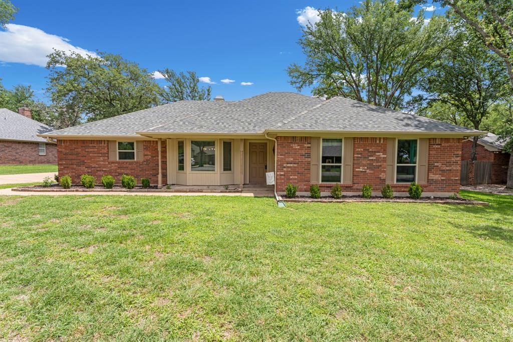 Nestled beneath a canopy of mature trees on an oversized lot, this inviting one-story brick home offers the comfort, space, and lifestyle buyers love in DeCordova Bend Estates. This home has been immaculately cared for inside and out. Inside, you'll find durable tile plank flooring throughout, neutral paint colors, and a spacious living room with a vaulted ceiling, cozy wood-burning fireplace, and glass windows and door that open to the expansive backyard. The kitchen is designed for everyday living with granite countertops, a stainless dishwasher, double ovens, microwave, and abundant workspace. The private primary suite offers generous space, a walk-in closet, and an ensuite bath with dual sinks, a soaking tub, and a separate walk-in shower. Two additional bedrooms and a guest bath provide flexibility for guests, or a home office. A full-size laundry room adds convenience.  Step outside to the extended covered patio, creating the perfect space for outdoor dining, entertaining, or simply relaxing while enjoying the shade. The oversized backyard is fully fenced and offers endless possibilities for pets, play, gardening, or future outdoor enhancements. There is also a storage building on a concrete slab. A roof that's only three years old adds peace of mind. Life in DeCordova Bend Estates is about more than just the home. Enjoy 24-hour gated security, championship golf, Lake Granbury access with a marina, a community pool, pickleball, tennis, basketball, volleyball, playgrounds, and a vibrant clubhouse with dining and year-round activities. Whether you're looking for a full-time residence or a lock-and-leave lifestyle, this move-in ready home lets you enjoy everything this sought-after community has to offer.
