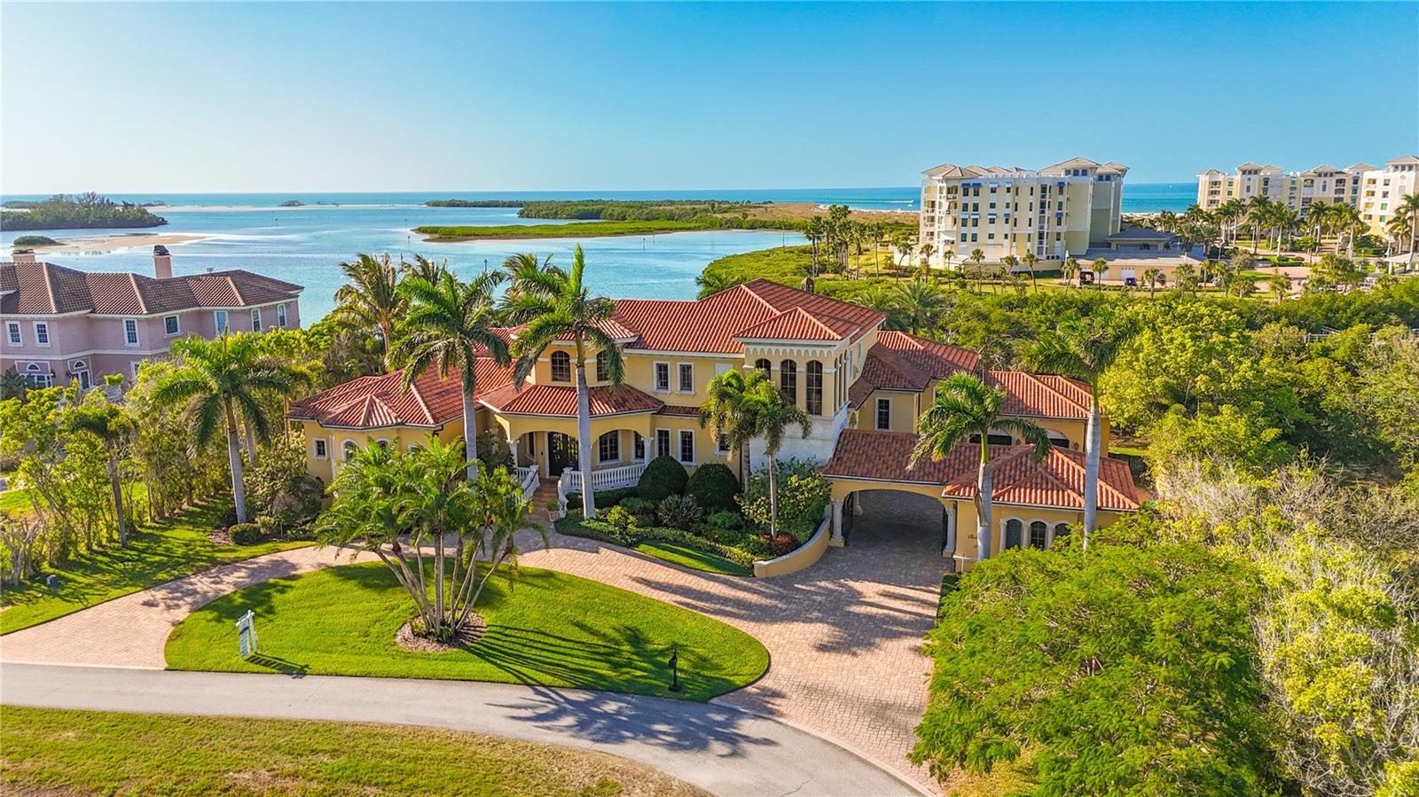 Once a hidden gem, Oceanview Drive in Tierra Verde has become one of Tampa Bay’s most sought-after waterfront addresses — and 1363 Oceanview Drive stands as a true showpiece along its shoreline.Designed for both privacy and entertaining, this extraordinary estate delivers the best of waterfront living. Perfectly positioned on the water with breathtaking southwest views of Shell Island Preserve and unforgettable sunsets, the property features a modern oversized dock complete with two boat lifts, a double jet ski lift, multiple boat slips, and easy-access ladders for paddleboards, kayaks, and canoes.Lush, manicured landscaping provides a serene sense of seclusion while still allowing abundant natural light and outdoor enjoyment. The resort-style swimming pool was re-marcited in 2022, a new pool heater was added in 2021, and the surrounding travertine decking was coated with a non-slip finish in 2020. An expansive outdoor entertainment pavilion includes a built-in BBQ station, a three-sided full bar with appliances, dining and lounge areas, a fireplace, and a mounted flat-screen TV. The ceiling is pre-wired for speakers, fans, and misting systems. A separate one-bedroom, one-bath pool house offers ideal accommodations for guests.The main residence is the crown jewel — a 4-bedroom, 4-full-bath estate with two additional half baths and three garages capable of housing up to five vehicles or recreational toys. An elevator provides effortless access to each level, from garage to kitchen to bedroom floors — ideal for daily convenience and ease of living.Through the grand double iron entry doors, you’re welcomed into a stunning parlor with a double-sided fireplace shared with an executive office. The south wing leads to the luxurious primary suite, which opens to its own outdoor patio overlooking the pool, spa, and waterway. Dual walk-in closets with center jewelry island, separate vanities, dedicated sitting areas, a soaking tub, and a large walk-in shower complete the spa-like primary bath.To the north of the parlor lies a formal dining room adjacent to a private, temperature-controlled wine cellar. The chef’s kitchen features hidden refrigerator/freezer panels, L-shaped custom cabinetry, a gas range, and premium stainless-steel appliances. Upstairs, three additional bedrooms, three full baths, a second living area, coffee/wine bar, and laundry room create a thoughtfully designed private retreat level.What truly sets this home apart is its dedicated entertainment wing — a private bar, billiards room, arcade space, and a fully equipped movie theater. The bar is designed to impress, with multiple TVs, seating areas, and space for pool, darts, or game-day gatherings. The theater was recently upgraded with over $40,000 in new projection, audio, visual, and screen equipment.Meticulously maintained and upgraded, the seller has spared no expense in recent years. From 2021–2023, interior travertine floors were buffed and polished, the parlor received new cherry hardwood flooring, gutters were repaired and cleaned, and over $40,000 was invested in new central AC systems. In 2025, a $150,000 dock renovation further enhanced the property’s waterfront lifestyle.This is more than a home — it is a private waterfront resort built for luxury living, effortless entertaining, and unforgettable sunsets.
