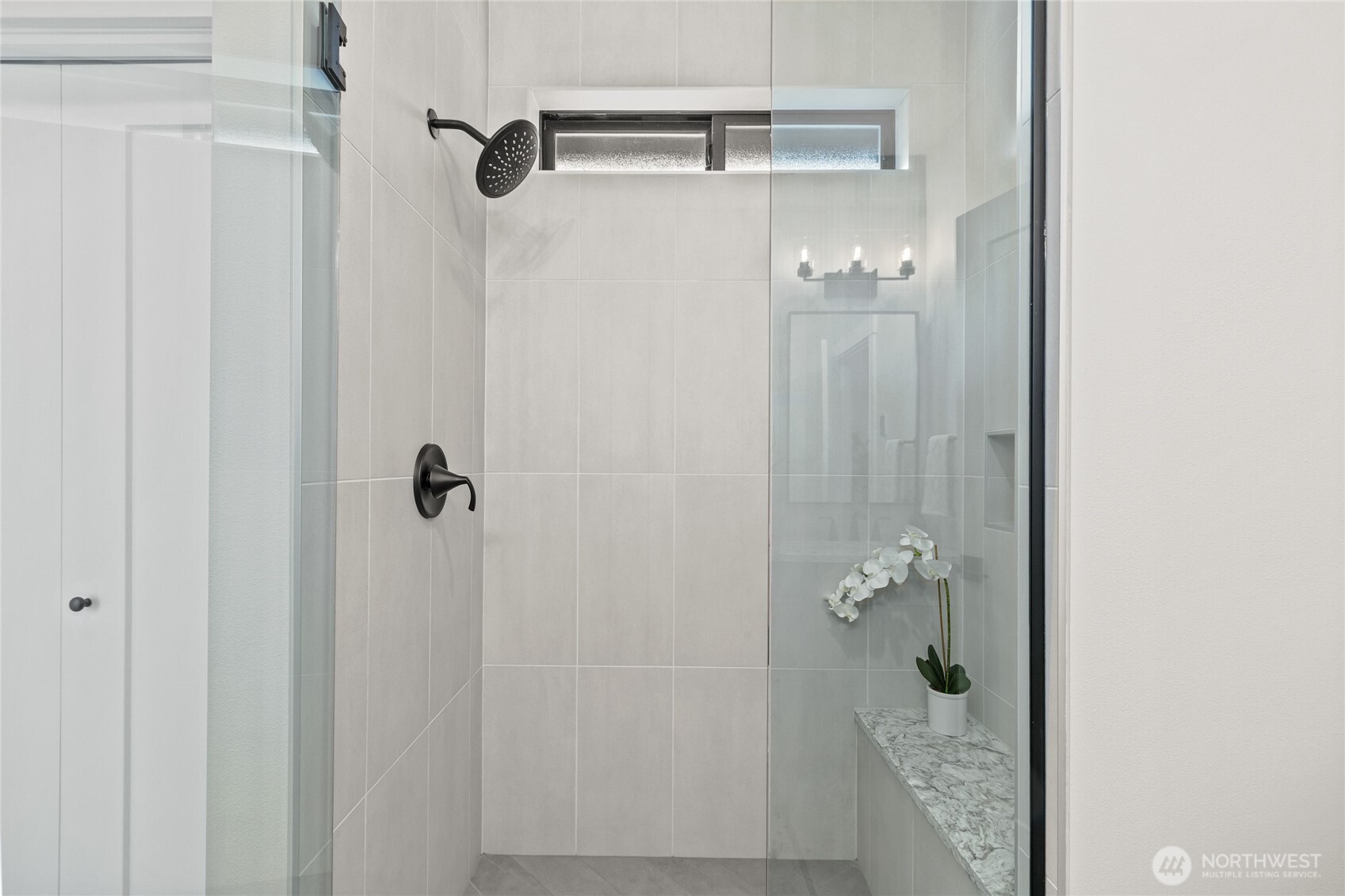Primary bathroom with walk in shower and closet.