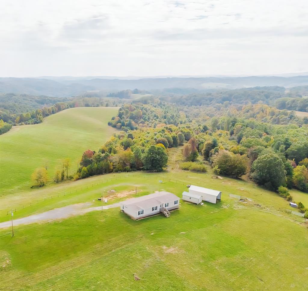 Discover the perfect blend of privacy, natural beauty, and functionality on this stunning 72+/- acre farm, boasting sweeping long-range views of the Blue Ridge Mountains. Fully fenced and equipped with watering boxes, the land is ready for your livestock and ideal for a self-sufficient lifestyle. The spacious 4-bedroom, 2-bath home features an open floor plan with soaring 9-foot ceilings, offering comfortable and airy living spaces. A small barn, shed, and working pen provide everything needed for your agricultural needs. Teeming with wildlife and located just minutes from the scenic New River, this exceptional property offers a rare opportunity to enjoy peaceful country living with modern conveniences in a truly breathtaking setting. Schedule your tour today!