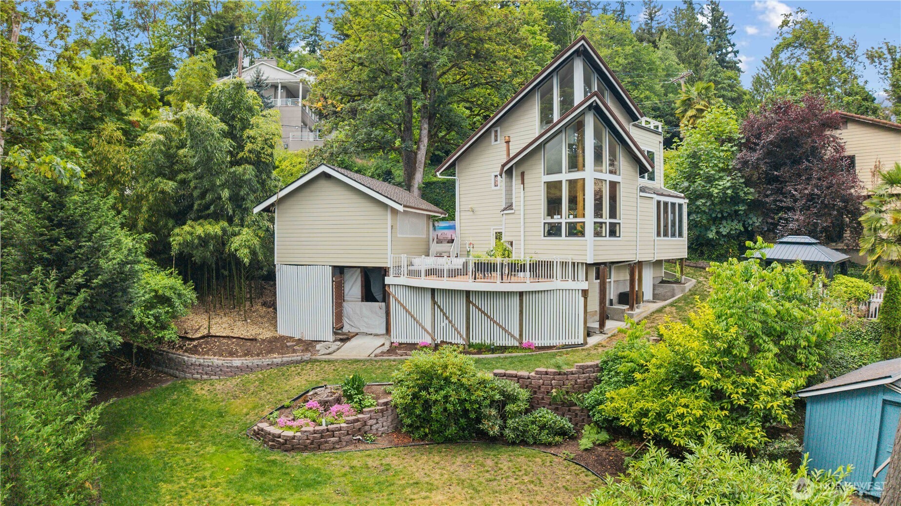 Enjoy Views of Mt Rainier & Lake Washington from all 3 levels through vaulted walls of windows and 2 entertaining decks from this Mountain Lodge styled home. Dramatic floor to ceiling River Rock Fireplace, Antique Petrified wood flooring throughout. Watch Eagles soar in front of your home while preparing meals in your custom designed gourmet kitchen with renowned Rutt Cabinetry. This Home features top appliances Sub-Zero, Dacor Convection Oven, Viking Cooktop, High Energy Efficient Heating & A/C. Primary Suite with sitting room/office, beautiful bathroom. New Presidential 50yr roof w/newer siding. Golf driving room to enjoy! Beautiful grounds throughout, backyard w/entertaining paved patio w/gazebo for relaxing/barbecues, & planting beds.