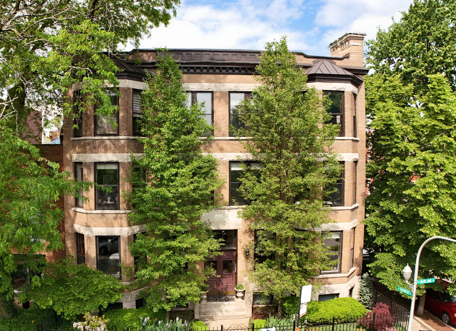 Sun-Drenched Top-Floor 3 Bedroom / 1 Bathroom Vintage Condo in Coveted Lincoln Park & Alcott School District. Welcome to this beautifully updated, sun-filled condo, ideally located on a quiet, tree-lined street in the heart of Lincoln Park-just steps from shops, dining, parks, and public transit, and within the highly sought-after Alcott School District. Step inside to soaring 10-foot ceilings, hardwood floors throughout, and a spacious foyer with a coat closet. The inviting living room boasts original oversized bay windows, a stunning wood-burning fireplace, and stylish West Elm lighting, flowing seamlessly into a formal dining area-perfect for entertaining. The remodeled classic white kitchen features brand-new stainless steel appliances (fridge 2024; range, microwave, and dishwasher 2025), Calacutta quartz countertops, and a generously sized island ideal for prep and casual dining. A front-loading washer (2025) and dryer are also conveniently located in-unit. The bathroom is timeless, finished with elegant marble tile, ample storage, and a bright, south-facing window. Each of the three bedrooms offers something special: The front bedroom is sunlit from the east and features a charming original built-in hutch and views of mature pear trees. The middle bedroom includes a spacious walk-in closet. The third bedroom, just off the kitchen, enjoys warm west-facing light and overlooks the private deck. Relax on your private deck, surrounded by lush cherry trees, western sun and overlooking a beautifully landscaped common garden. The fenced front yard is professionally landscaped and equally serene. Extras and Amenities: Dedicated exterior parking space (end spot) Large private storage room in basement (11'x6') Intercom system linked to your cell phone, 4 AC window units included, Exceptionally well-run and proactive 6-unit HOA with over $55k in reserves, Routine building maintenance: annual radiator and fireplace checks, boiler flushing, and professional cleaning of common areas. Assessment covers: heat, water, trash/recycling, common insurance, snow removal, bike room, intercom, and tree service. Important Notes: All owner-occupied building. No dogs or rentals allowed. Enjoy the best of city living just steps to Trader Joe's, The Fresh Market, restaurants, cafes, home improvement stores, public transportation, lakefront trails, and parks-all within walking distance.