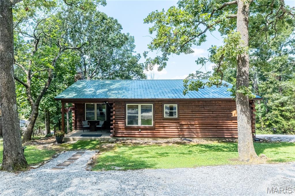 Nestled among the trees at beautiful Lake Perry, this charming 3-bedroom, 1.5-bath cabin is a true gem. Completely updated within the last two years, this eye-catching home showcases the care and attention the current owners have invested since purchasing the property.Step inside and you'll immediately appreciate the modern finishes and inviting atmosphere. Everything has been updated, including gorgeous granite countertops and stainless steel appliances. The accessible crawlspace provides excellent additional storage, a rare and practical feature. There is a water view from the top deck.Enjoy everything Lake Perry has to offer, including a 200-acre (more or less) spring-fed lake, a community in-ground pool, sandy beaches, playgrounds, pavilions, a seasonal restaurant, and much more. This home is conveniently located within walking distance of the community swimming pool, making it easy to enjoy the amenities.For added comfort and energy efficiency, the entire home—including the attic and crawlspace—has been insulated with conditioned spray foam. The washer and dryer are also included, making this move-in-ready cabin an exceptional opportunity to enjoy lake living at its finest.