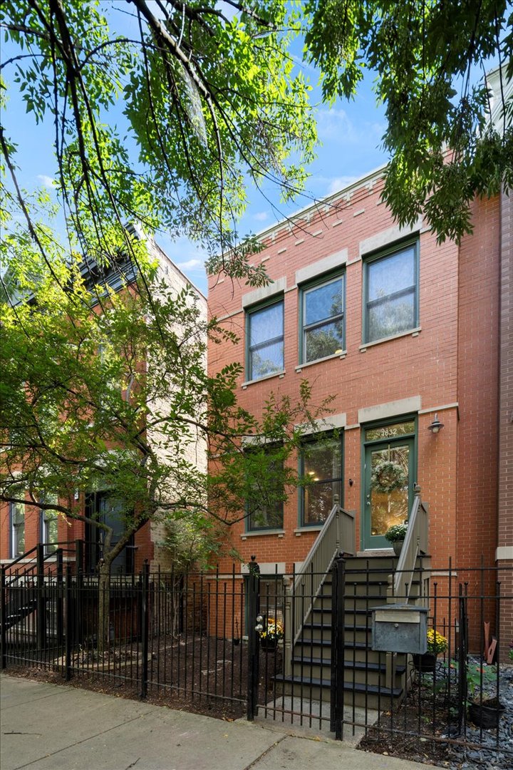 Located on one of Bucktown's most sought-after blocks, this contemporary and sunny three-bedroom, three-bathroom rowhouse checks every box: three levels with multiple living spaces, private backyard, two-car garage, and thoughtful modern updates. From the street, this brick beauty impresses with fantastic curb appeal, featuring newly built front steps and a blooming tree that changes with each season. It is ideally situated on the end of the row, allowing for a convenient pathway from front to back. Come up the stairs and step inside the home, and immediately, you will notice the tall ceilings, cozy fireplace, stylish chandelier, and gleaming hardwood floors. The living room seamlessly connects to the dining room, creating the perfect setting for both entertaining and everyday living. The kitchen has a timeless feel thanks to quartz countertops, pristine white cabinetry with gold pulls, and a wall of French doors that flood the room with sunlight. This home's generous kitchen layout accommodates barstools, a breakfast nook (may also be used as a playroom or additional living space), and an additional wall of kitchen cabinetry with a wine fridge. Outside, discover a private backyard retreat. The deck fits a grill and outdoor dining table, and it overlooks a sun-soaked turfed yard with a tall leafy tree, pavers, and pebbles. It's an inviting, low-maintenance oasis designed for gatherings both large and intimate. Upstairs, you will find two of three bedrooms. The primary bedroom is oversized and boasts treetop views of beautiful Wilmot Avenue. Its luxurious en-suite bathroom has been completely renovated with new tile, a striking blue vanity with coordinating blue shower niche, and gold fixtures. A skylight fills the bathroom with natural light. Across the hall, the expansive second bedroom is soaked in sunlight. The second bathroom has been updated with playful black-and-white floor tile, new vanity, and matte black hardware. The lower level offers incredible versatility, with a spacious family room, third bedroom, and third full bath. Wide-plank luxury vinyl floors add warmth and durability throughout this level. This home has been extensively updated inside and out: renovated kitchen and baths, refreshed backyard, new flooring upstairs and downstairs, new front stairs, a redesigned fireplace surround, new LED lighting throughout, and the list goes on. As for the location, it truly cannot be beat. You are moments from the 606 (with direct access down the block at Milwaukee and Leavitt), Ehrler Park, Holstein Park, Milwaukee and Damen Avenues, restaurants, coffee shops, grocery stores, and so much more.