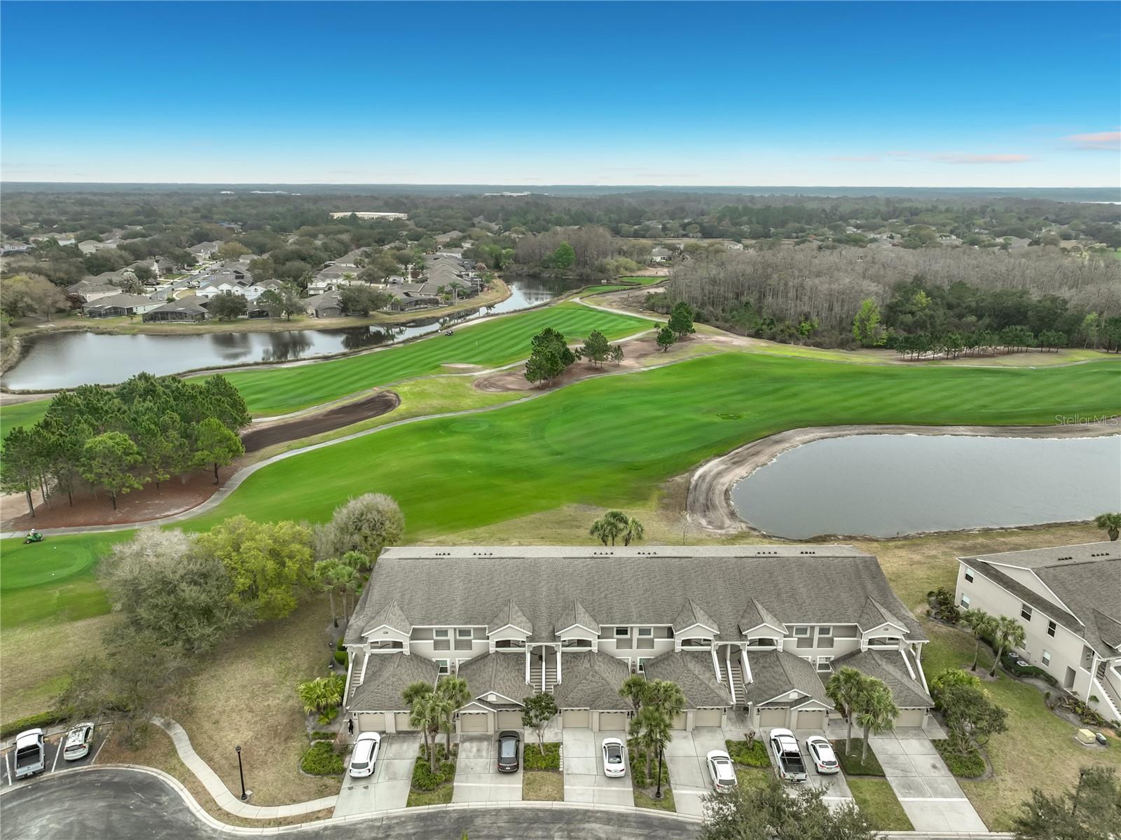 Welcome to this meticulously maintained 2-bedroom, 2-bathroom second-floor condominium in the highly desirable Verandas at Lake Hart, located within the gated North Shore at Lake Hart community in Lake Nona. Perfectly positioned on the 7th fairway of the North Shore Golf Club, this move-in-ready home offers beautiful golf, pond, and conservation views that create a peaceful and scenic backdrop. Freshly painted and thoughtfully updated, the residence features new wood-look plank tile flooring, nine foot tray ceilings, updated lighting, ceiling fans, and mirrors throughout. The open-concept layout seamlessly connects the living and dining areas, providing comfortable space for both relaxing and entertaining.The split-bedroom floor plan ensures privacy, with two generously sized bedrooms and two full bathrooms. The primary suite includes a private shower/bath combination and dual closets, while the secondary bedroom offers ample space for guests, a home office, or additional living needs. The eat-in kitchen is well-appointed with 42-inch cabinetry, a large pantry, and abundant storage. A one-car garage and plentiful interior storage add to the home’s functionality and convenience. Residents of North Shore at Lake Hart enjoy access to resort-style amenities including a clubhouse with fitness room, two swimming pools, tennis courts, basketball court, playground, dog park, and gated security. Ideally located just minutes from Orlando International Airport and the vibrant Lake Nona area—including Medical City, the VA Medical Center, USTA National Campus, shopping, dining, and major highways—this condo offers the perfect combination of convenience, lifestyle, and value. Whether you’re seeking a primary residence or a low-maintenance investment in a sought-after location, this exceptional golf-front property is priced to sell and ready for its next owner.
