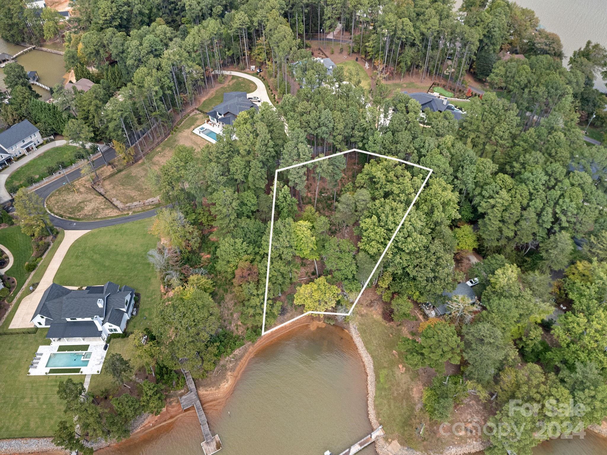4 Bedroom Septic PLUS dock permit approved! Your Lake Norman dream home awaits! Nestled in a peaceful cove on the Brawley Peninsula this leveled waterfront lot offers a great opportunity to build your Lake Norman dream home on .77 acres. 155 Binns Road is located just beyond The Point is one of Lake Norman's most desired areas offering incredible lake living on a beautiful, private street with no HOA. Trump National Golf Club  Charlotte is minutes away offering the best of golf, tennis, dining, pool & community events.
