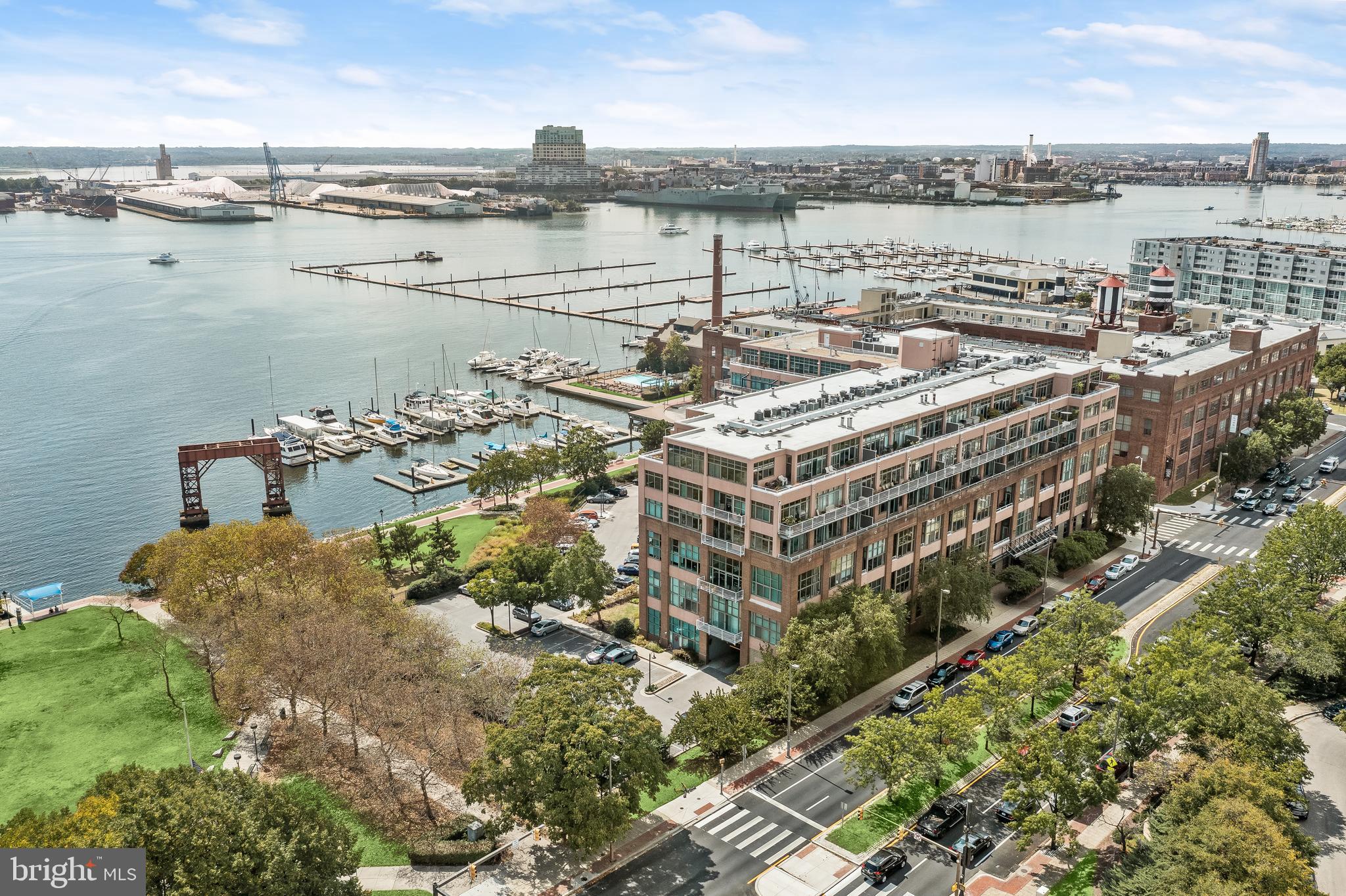 Introducing this exceptional three bedroom, two-and-a-half-bathroom condominium with two levels of luxurious living in the highly-coveted Canton Cove. Located on the third floor, this unit was just completely renovated top-to-bottom, offering nearly 2,000 square feet with a neutral color palette and abundant natural light throughout. Step into the foyer to new luxury vinyl plank flooring and modern lighting that continue throughout. Tall ceilings feature accent wood planks, while the living room and main level bedroom suite boast soaring 17-foot ceilings and oversized windows. The gourmet eat-in kitchen offers quartz countertops, classic subway tile backsplash, shaker-style cabinets with under-cabinet lighting, stainless steel appliances with gas cooking, and a generous pass-through window to the dining room. A kitchen nook is ideal for a breakfast table or walk-in pantry for extra storage. Relax or entertain in the expansive open-concept living and dining spaces with floor-to-ceiling windows and balcony access. The redesigned main level includes a bedroom suite with a walk-in closet, additional balcony access, and private bathroom. Finishing the main level is a laundry room and a half bathroom. Upstairs, the primary bedroom suite serves as a luxurious retreat with its own walk-in closet and ensuite bathroom. A third bedroom and a large storage room complete the upper level. This prestigious community offers an array of spectacular amenities, including 24-hour security with a staffed lobby desk, elevators, a meticulously landscaped courtyard, and a rooftop terrace with panoramic views that is an ideal setting for hosting gatherings with friends. The location is equally impressive, with the Waterfront Promenade and Canton Waterfront Park just steps from your door. Enjoy easy access to the Canton Crossing shopping center, Merritt Clubs Canton, O’Donnell Square, and a plethora of outstanding restaurants, shopping venues, and entertainment options. One outdoor parking spot (#17) is included with the residence, and the monthly condo fee covers gas, water, and maintenance of the common grounds, ensuring a truly luxurious and hassle-free lifestyle. Some images have been virtually staged.