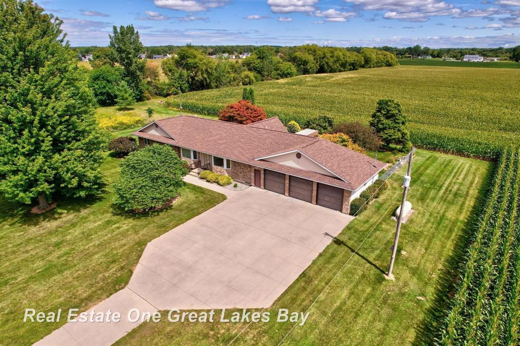 Nearly 2,600 sq. ft. Ranch on 47 Acres in Freeland Schools! This rare find offers a spacious 3 bedroom, 2.5 bath ranch with almost 47 acres of land-most of which is currently cropped, providing rental income or the potential to split into multiple parcels. The home itself sits on just under 3 acres, complete with a fenced yard, a large deck, a terrace, and a peaceful koi pond. Inside, you'll love the open floor plan with a generous living room and a bright sunroom off the kitchen featuring vaulted ceilings. The kitchen is designed with entertaining in mind and offers ample cabinet space along with a walk-in pantry. The large primary suite includes a full bath and a naturally lit walk-in closet, while the second and third bedrooms also feature walk-in closets. Between the primary bedroom and the family room, a versatile bonus room provides endless possibilities as a nursery, office, study, or playroom. Convenience is built into the design with a spacious main-floor laundry room that includes a mop sink and plenty of space for a freezer. The huge 3 car garage is equipped with hot and cold plumbing and a 220 outlet already installed. The basement is clean and open with eight-foot ceilings and exterior Bilco doors, offering excellent storage or potential for future finishing. Very clean and move-in ready, this property combines comfortable living with endless opportunity and investment potential.