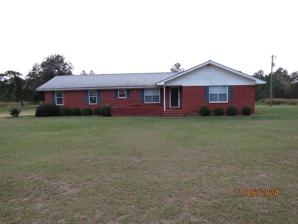 Baker County Acreage Near the River! Don't miss this solid 3BR/2BA brick ranch-style home nestled on 6.43 private acres. This property offers the perfect blend of peaceful acreage and unbeatable convenience—located just seven minutes from the Flint River boat landing. Step inside to find a welcoming, functional layout featuring an open kitchen and dining combo designed for easy gatherings. Storage will never be an issue thanks to the exceptionally large walk-in pantry, perfect for stocking up on essentials or housing your favorite kitchen gadgets. Outside, enjoy the charming brick patio while sipping your morning coffee, or for evening relaxation. Take advantage of a spacious 2 car carport to protect your vehicles, along with a wired workshop with awnings providing massive potential for hobbies, and extra storage. Whether you are an avid angler wanting quick river access or someone wanting privacy and acreage, this property has it all! Call today to schedule a showing!