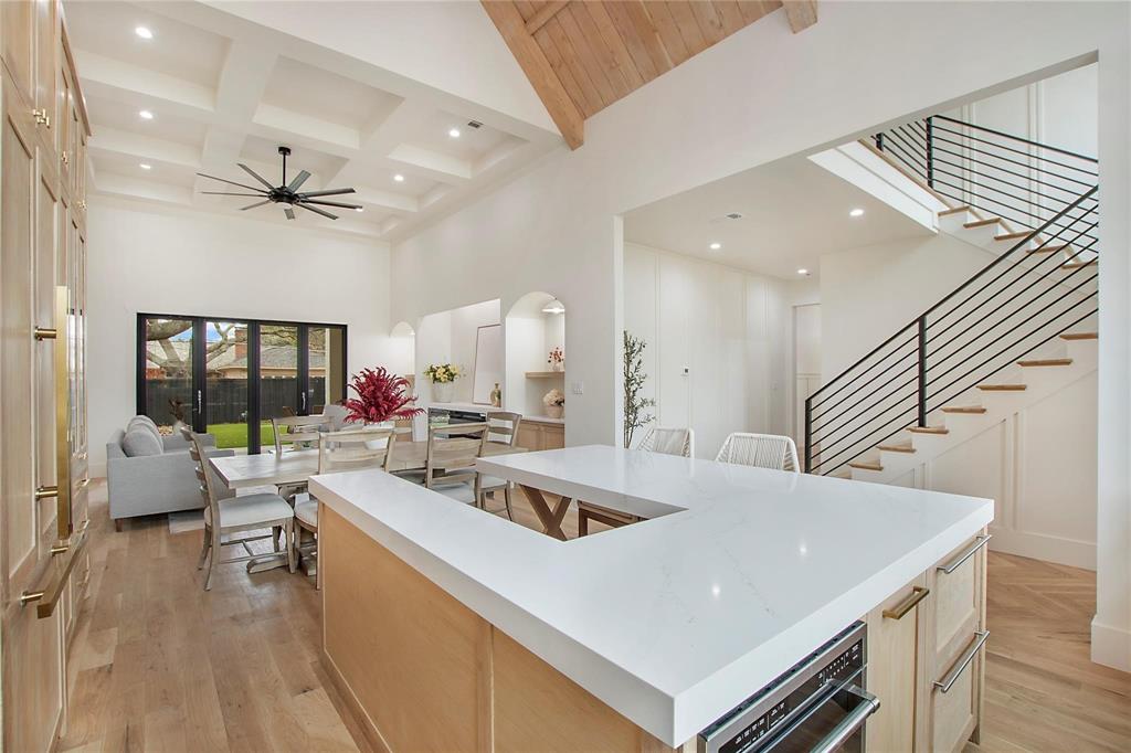 Experience new-construction quality in this never-lived-in 2023 build, set within the highly sought-after Richardson ISD and short walk to Mohawk Elementary. This pristine home delivers exceptional value, thoughtful design, and the kind of flexible layout today’s buyers crave. Perfect for multigenerational living or effortless hosting, the floor plan features two full primary suites and two laundry rooms, creating privacy, convenience, and long-term adaptability for families of all shapes and sizes.The chef’s kitchen is a centerpiece of the home, showcasing custom white oak cabinetry, dual-paneled refrigerators, and a large multi-use island with built-in seating—ideal for everyday living and entertaining. Accordion-style sliding doors open to a covered patio with a built-in grill and fireplace, blending indoor comfort with outdoor living. The fully turfed backyard and private putting green invite year-round play, relaxation, and memorable gatherings.  Inside, the open-concept living room impresses with a soaring cathedral ceiling and a dramatic stone feature wall drenched in natural light. Elevated finishes shine throughout the home: hand-scraped wood floors, sleek black exterior windows, spa-inspired bathrooms, tankless water heater, spray-foam insulation, epoxy-coated garage floors, and seamless gutters with circular downspouts. Even pets get their own luxury perk with a dedicated doggie shower. Move-in ready, luxurious, and located in one of Richardson’s premier neighborhoods, this home blends modern design with long-term livability and an unbeatable walkable location.  The seller is open to seller financing and is even willing to consider a house swap—providing unique flexibility for the right buyer.