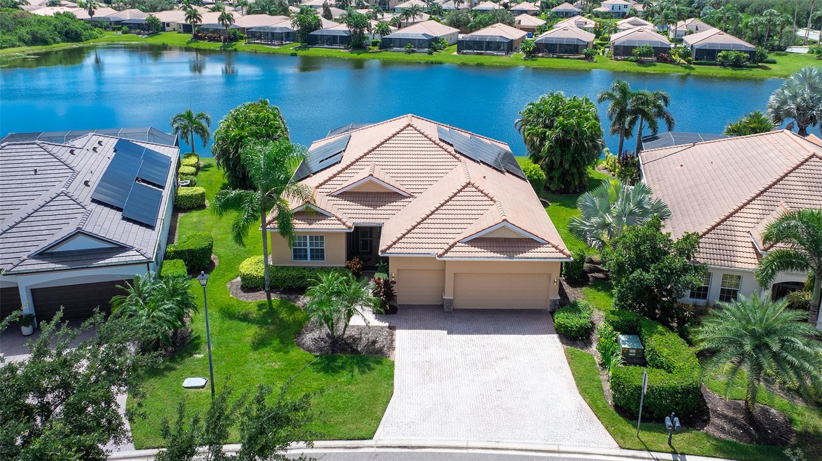 GOLF-DEEDED, WATERFRONT AND TURNKEY FURNISHED – this exceptionall 4-bedroom, 2 bath pool home in River Strand Golf and Country club offers the Florida resort lifestyle buyers are looking for.  Set on 120 feet of waterfront with desirable southern exposure, the home features a screened saltwater pool and spa, whole-house solar power, a 3-car garage, and more than $100,000 in improvements and upgrades.  Inside, the home is beautifully furnished with newer 2024 furniture and includes luxury vinyl plank flooring, upgraded appliances, a whole-house water softening system, and an 85- inch and 65-inch ultra-HD television.  The 23kW whole-house solar system powers both the home and pool, helping keep the electric bill to approximately the utility meter charge. The salt water pool/spa conversion and a new energy-efficient, super quiet Invertech i18 pool heater/cooler heat pump can be left running continuously on solar power with no need to plan ahead. The three-car garage is equipped with an EV charging station, a Generac generator-ready electrical panel, and ample ceiling-mounted storage that keeps belongings organized while maximizing usable garage space.  Add a whole home battery and have unlimited days of quiet power should the grid go down. Recently installed 6" gutters stop overflow, and they protect the home's foundation, siding, and landscaping from erosion and water damage. Offering four bedrooms and 2 full baths, the flexible floor plan provides plenty of space for a home office, hobby room, or overnight guests. Best of all, the coveted southern exposure bathes the pool and outdoor living area in glorious sunshine throughout the day. Relax beside the low maintenance saltwater pool while enjoying over 100 ft. of  tranquil water views. A freshly painted interior and seamless transition to the lanai and pool deck create an inviting setting for entertaining or simply enjoying the Florida lifestyle. Inside, high-end luxury vinyl plank flooring enhances the main living areas, complemented by neutral interior paint throughout. The updated kitchen features quartz countertops and upgraded appliances. Offered turnkey furnished with new furniture, this home also includes 85-inch and 65-inch ultra-high-definition televisions, making it ready to enjoy from day one.An extraordinary resort lifestyle awaits within this gated community. Golf membership provides access to a fabulous 27-hole championship golf course. Golf enthusiasts will appreciate the professional golf staff, fully equipped pro shop, and exciting calendar of tournaments and events. Racquet-sports amenities are equally impressive, with eight pickleball courts, nine Har-Tru tennis courts, professional tennis and pickleball instruction, and organized tournaments. An incredible $11 million renovation has transformed the clubhouse, dining venues, and expansive outdoor dining patio. Residents also enjoy a vibrant social calendar featuring weekly activities,and countless opportunities to connect.Located within a master-planned community, this home places exceptional shopping, dining, healthcare, and everyday conveniences close at hand—including Costco, Target, Whole Foods Market, Seasons 52, LongHorn Steakhouse, Chick-fil-A, medical offices, and more. The prime location provides convenient access to I-75, Gulf Coast beaches, area airports in Sarasota, Venice, St. Petersburg and Tampa.This is more than a home—it is the complete Florida resort lifestyle you have been waiting for!