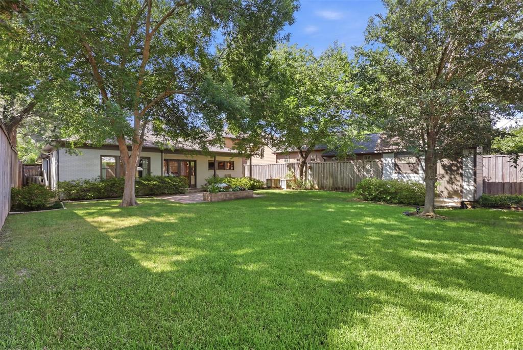 One-of-a-kind, SINGLE STORY Bluffview beauty!  Enveloped by the winding, tree lined topography that defines Dallas’ most storied enclave, this 4 bedroom brick and stone exterior home has a unique mid-century modern feel.  Original hardwoods flow throughout two generous living areas and walls of windows.  An elevated ceiling with clerestory windows brings in even more natural light. The open plan living, dining, and kitchen area has double doors that open out to a covered back patio and large fenced yard perfect for pets, kids, and plenty of room for a pool.  The fully equipped kitchen boasts a built-in refrigerator, stainless gas cooktop & vent hood, double ovens and an great island with seating and a vegetable sink. The garage features aluminum translucent glass overhead door and loads of built-in storage.  Bluffview Park is just a quick stroll down the street.  Ideally situated near Inwood Village, Dallas Love Field, premier private schools, Downtown Dallas and the Dallas North Tollway, this location is as convenient as it is coveted.