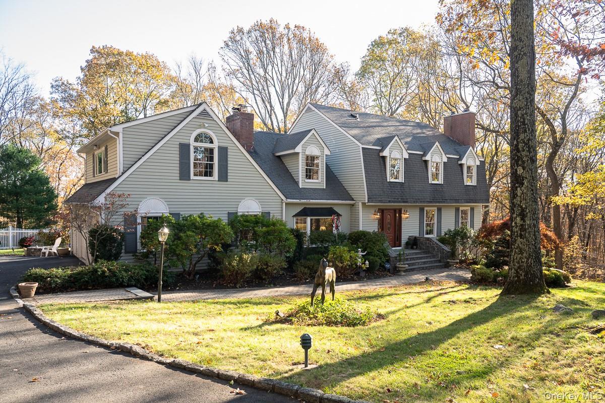 Sprawling colonial where tranquility meets sophistication. Imagine spending the summer relaxing or entertaining poolside on this stone patio, set on over 2 acres of rolling landscape with mature gardens, all surrounded by protected land.  The interior opens to a generous foyer, a formal living room w/fireplace, formal dining room and large sunken family room with custom woodworking, a fireplace and wet bar. The kitchen is equipped with high end appliances, granite countertops, a breakfast nook, and includes sliders to a large deck. 4 bedrooms are located on the second floor.  The primary suite has a fireplace, ensuite bath, and generous closet space; w/d conveniently located down the upstairs hall. Vaulted ceilings and lots of windows fill the game room with abundant natural light, and add architectural interest to the space. A total of 3700 square ft of living space completes the main living quarters. The lower level features an additional  1100 square foot of living space with a legal kitchen, playroom, full bath and separate washer/dryer.  Located at the end of a cul-de-sac, convenient access to highways, parks, trains and shopping in multiple neighboring towns.  Bedford Schools. A must see to truly appreciate all that this listing has to offer!
