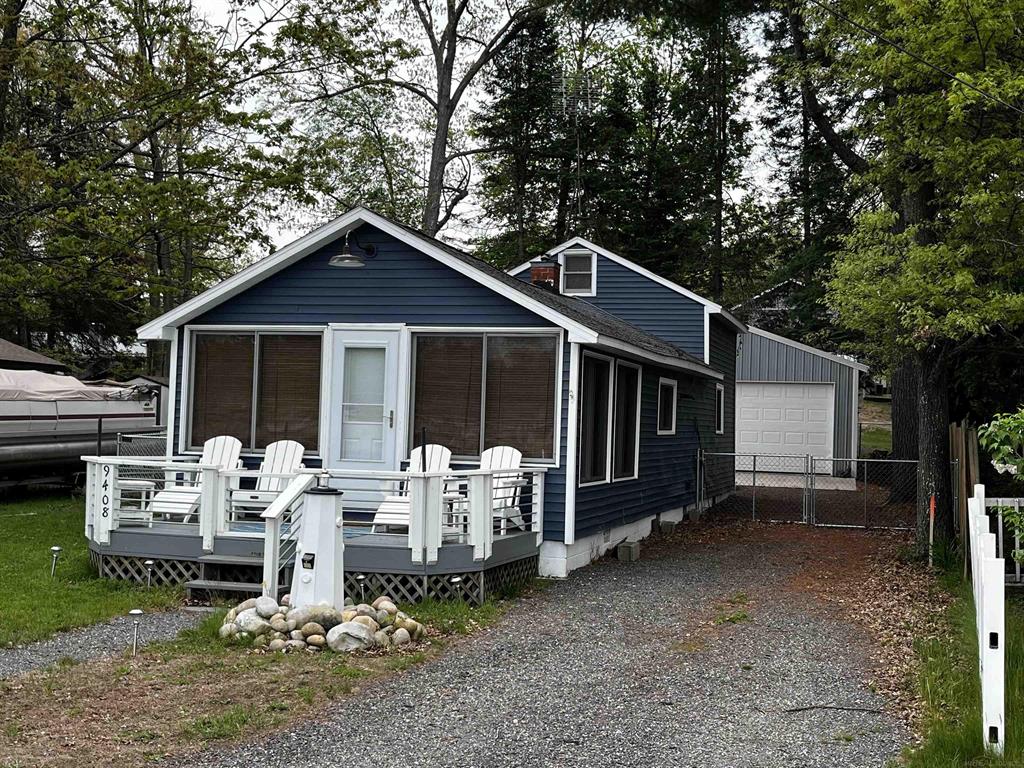 Welcome to Your New Waterfront Retreat by the Lake! This charming and fully furnished 3-bedroom, 1-bath home with a spacious loft featuring 2 additional beds is the perfect getaway or year-round residence. Ideally situated directly across from the marina, this property boasts breathtaking lake views from the comfort of your living room-offering the perfect blend of peace, recreation, and convenience. Step inside and feel instantly at home. The open living area is filled with natural light and offers stunning views of the waters of Lake St. Helen. Whether you're relaxing after a day on the lake or hosting family and friends, this home has everything you need. Out back, you'll find a generous 20 x 24 garage-ideal for storing your boat, snowmobiles, four-wheelers, or any of your Up North adventure gear. A cozy firepit awaits for chilly evenings under the stars, making it a perfect gathering spot after a day on the water or trails. The second driveway provides even more flexibility, with plenty of space to park trailers, boats, or multiple vehicles. It also offers additional access to the backyard, which is fully enclosed by a brand new privacy fence, creating a safe and secure space for kids and pets to play freely. This home is truly move-in ready, complete with all kitchen appliances, a washer and dryer, and comfortable furnishings throughout. Just pack your bags and start enjoying life by the lake! As a bonus, residents enjoy private beach access on nearby Tippedy Lane-perfect for swimming, sunbathing, or launching a kayak. You'll also have the option to secure a boat dock through the Association, or lease a slip at the marina right across the street, directly in front of your home for the ultimate in lakeside convenience. Whether you're seeking a primary residence, a weekend getaway, or a highly desirable Airbnb investment, this waterfront gem checks all the boxes. Don't miss your chance to own a slice of paradise on Lake St. Helen-schedule your showing today!