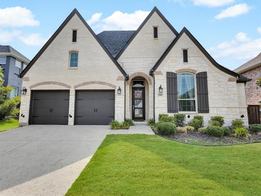 Experience modern luxury in the heart of award-winning Windsong Ranch. Built by Highland Homes, this single-story residence blends sophisticated design with exceptional functionality, offering 3 bedrooms, 2.1 baths, a dedicated office, and a versatile media room designed for entertainment, hobbies, or quiet retreat. Soaring 11’ ceilings and expansive picture windows fill the home with natural light, creating an airy, inviting atmosphere. The open-concept kitchen is anchored by a stunning quartz waterfall island, complemented by sleek cabinetry, stainless steel GE appliances, and an elegant backsplash. The spacious living area centers around a modern fireplace, while the formal dining room provides the perfect setting for gatherings. The private primary suite boasts oversized windows, a spa-inspired bath with dual vanities, and abundant storage. Each secondary bedroom includes a walk-in closet, ensuring every space is both functional and refined. A 13’ x 13’ covered patio extends the living space outdoors, overlooking a generous yard. Enjoy the unparalleled lifestyle of Windsong Ranch with access to the Crystal Lagoon, miles of trails, resort-style pools, tennis courts, fitness center, and more - all just minutes from Prosper’s top-rated schools, dining, and shopping. With a new roof in February 2025 and timeless finishes throughout, this home is move-in ready and designed for everyday luxury.