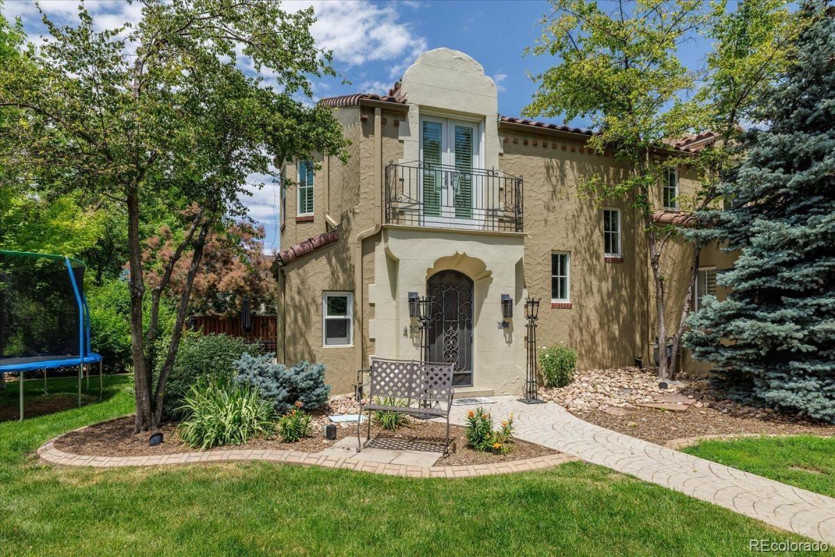 Tucked behind private security gates and surrounded by mature trees on a beautifully landscaped 10,000-square-foot lot, this exceptional Spanish-inspired residence offers a rare combination of architectural character, privacy, and modern functionality.A striking Spanish tile roof, charming courtyards, and multiple cobblestonlike patios create inviting outdoor living spaces that seamlessly connect to the kitchen and great room—ideal for entertaining or enjoying Colorado's beautiful seasons. The walled grounds provide a level of privacy seldom found along iconic 6th Avenue Parkway.Inside, thoughtfully designed living spaces are enhanced by custom built-ins, French doors, and abundant natural light. A charming study opens to a private patio, creating an inspiring work-from-home retreat. The spacious mudroom is exceptionally well-appointed with extensive built-ins and a dedicated pet-washing station. Elevator!!!The luxurious primary suite serves as a calm sanctuary, featuring a gas fireplace, French doors opening to a Juliet balcony, remodeled primary bathroom, and an extraordinary professionally designed walk-in closet. Four bedrooms and five bathrooms provide flexibility for family and guests.The walk-out lower level offers remarkable versatility with a private exterior entrance and interior access. Complete with its own kitchen, living room, bedroom, full bath, and closet, it functions beautifully as guest quarters, a nanny suite, a multigenerational living space, a private studio, or a home office.An oversized three-car garage is a standout feature, fully finished with built-in cabinetry, finished flooring, and heat—perfect for collectors, hobbyists, or additional storage needs.A truly distinctive property offering timeless architecture, exceptional privacy, and a premier location along one of Denver's most treasured parkways.