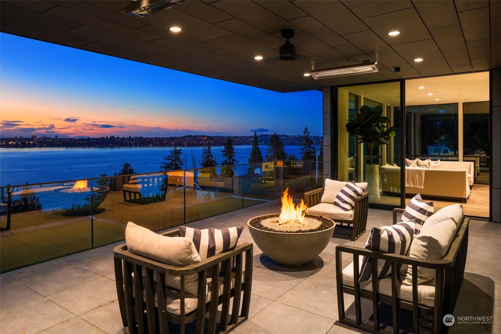 Experience the height of luxury in Medina with this exquisite newly constructed home by McCullough Architects, LH Design, and Hewitt Construction. Part of an enclave of 3 gated residences at the end of a private lane on Medina's coveted Evergreen Point, this prestigious 12,170 sq ft estate sits proudly on .79 acres with stunning views of Lake Washington, Seattle and the Olympics throughout. Designed as the ultimate gathering space for entertaining, it comfortably accommodates over 100 guests and showcases natural stone, 6 beds, 10 bathrooms, 6 fireplaces, an elevator, sauna, theater, wine room and tasting bar, two primary suites, 4-car garage, and seamless transitions from indoor to heated outdoor living. Shared waterfront, dock & moorage.