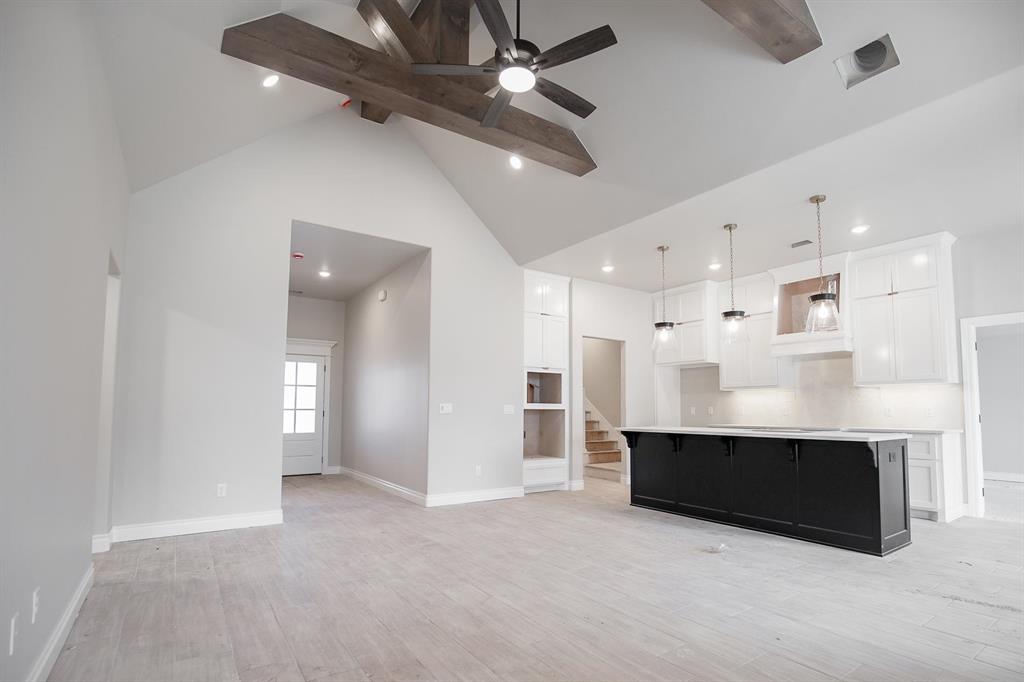 This Blue Spruce Bonus Room 1 floor plan includes 2,640 Sqft of total living space, which features 2,350 Sqft of indoor living and 290 Sqft of outdoor living space. There is also a 590 Sqft, three car garage with an in-ground storm shelter installed. This home offers 4 bedrooms, 3 full baths, 2 covered patios, a large bonus room, and a utility room. The great room welcomes a pristine cathedral ceiling with a crows feet detail, a ceiling fan, excellent wood-look tile, rocker switches throughout, Cat6 wiring, and large windows. The kitchen supports stainless steel appliances, a 5-burner cooktop, 3 CM countertops, a center island with a trash can pullout installed, well-crafted cabinets to the ceiling with under cabinet lighting and cabinet hardware installed throughout, exceptional pendant lighting, and a separate walk-in pantry. The primary suite features a sloped ceiling with a ceiling fan, windows, and our cozy carpet finish. The attached primary bath hosts separate vanities with framed mirrors, a European walk-in shower, a free-standing tub, a private water closet, and a HUGE walk-in closet. Outdoor living has a wood-burning fireplace, a gas line, and a TV hookup. Other amenities include our healthy home technology, a tankless water heater, a whole home air filtration system, R-44 insulation, and so much more!