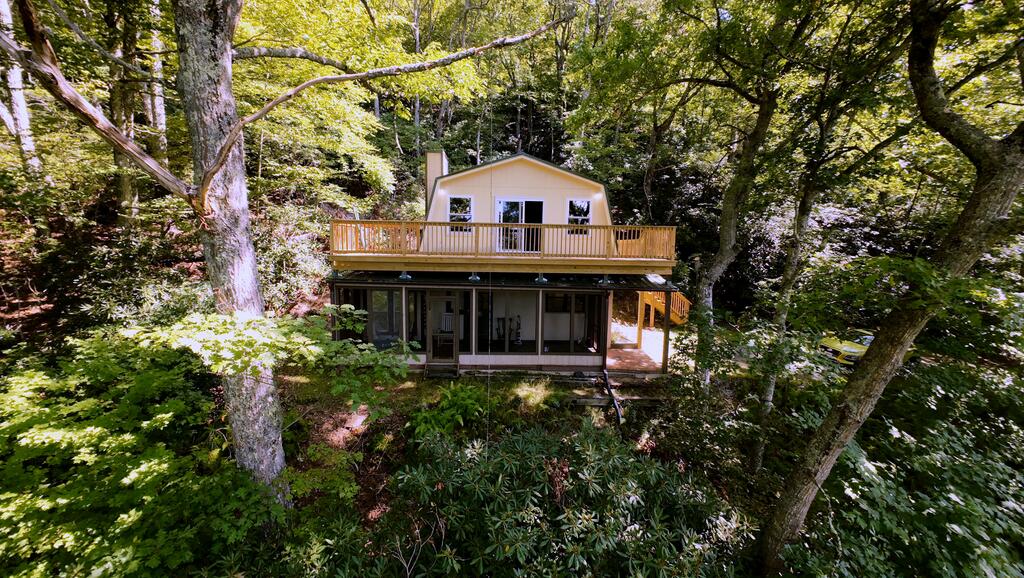 2 bd, 2 bath home on with 2 fireplaces and approximately 1 acre in the desirable Slatemont community, walking distance to the Blue Ridge Parkway. Surrounded by mature trees for privacy but a bit of tree clearing would provide spectacular long range southern views of Pilot Mountain and Hanging Rock state park. This home has a new deck with stairs to the driveway, new insulated windows and sliding doors on the bedroom level.  The main floor has a wide screened-in/covered porch for relaxing, laundry, kitchen and fireplace. The bedroom level has 2 bedrooms with new windows plus full bath and open living area with  fireplace.  The Property Owners Association provides the water which is unmetered, and road maintenance. Close to the Blue Ridge Parkway, 2 miles to Mabry Mill, 4 miles to Meadows of Dan, 2 miles to Chateau Morrisette and Villa Appalachia wineries, Buffalo mountain Zip lines, Primland Resort and golf, Old Mill Golf course, hiking, camping, music festivals and a host of other attractions.