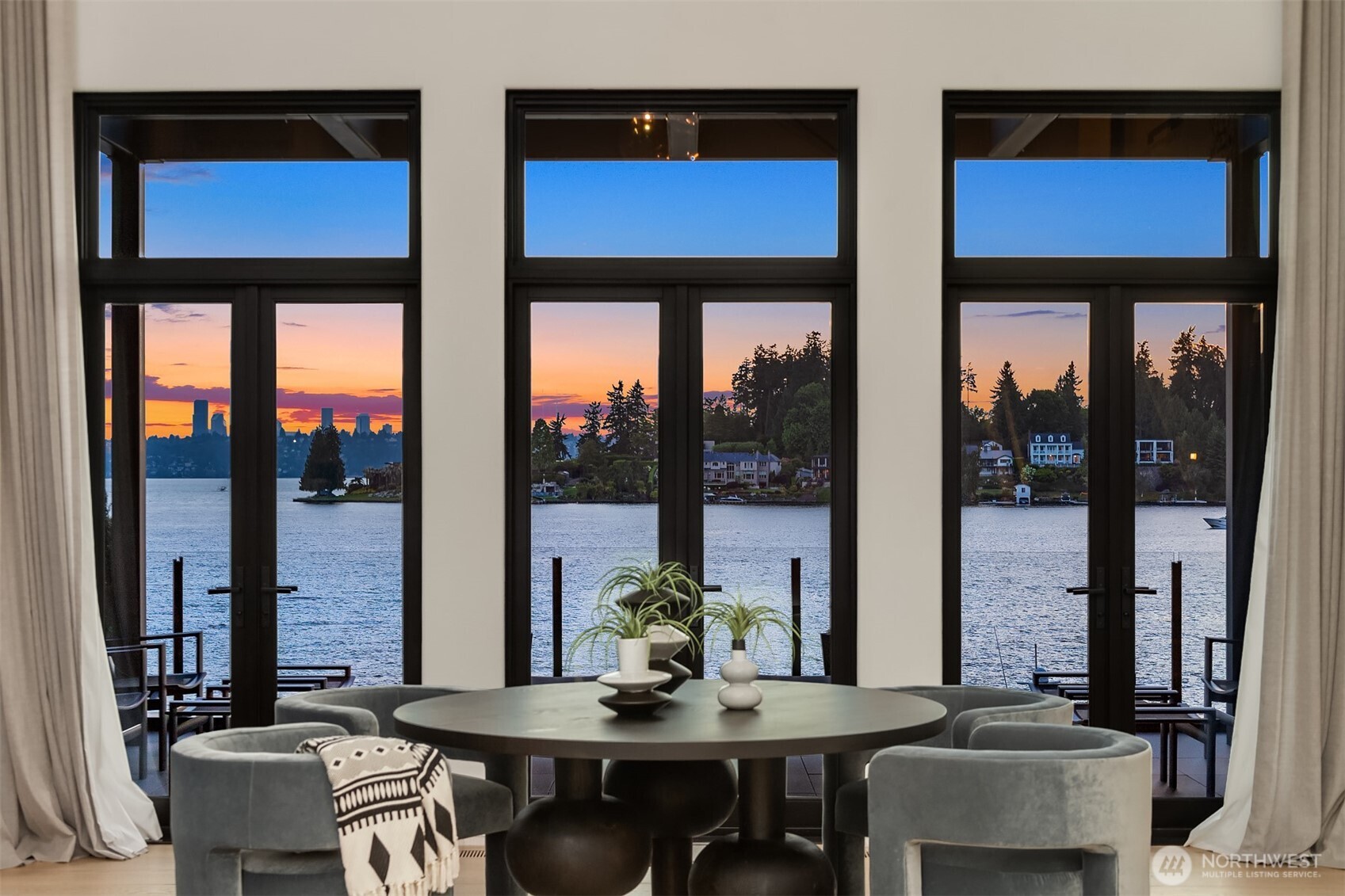 Waterfront luxury & modern sophistication define this like-new 6,290 sq ft masterpiece on Shoreland Drive. Redesigned by Toth Co, it showcases breathtaking lake, skyline & sunset views from every room, with expansive terraces that create seamless indoor-outdoor living. The main-level gourmet kitchens combine contemporary elegance with warmth, ideal for both culinary enthusiasts & entertainers. A stunning primary suite offers a spa-like bath & captivating water views. With elevator access throughout & a new private dock featuring dual hydraulic lifts & a 65ft yacht slip, this home redefines waterfront living—just minutes from Bellevue’s best. Thoughtfully designed with unmatched craftsmanship, it offers a lifestyle of true sophistication.