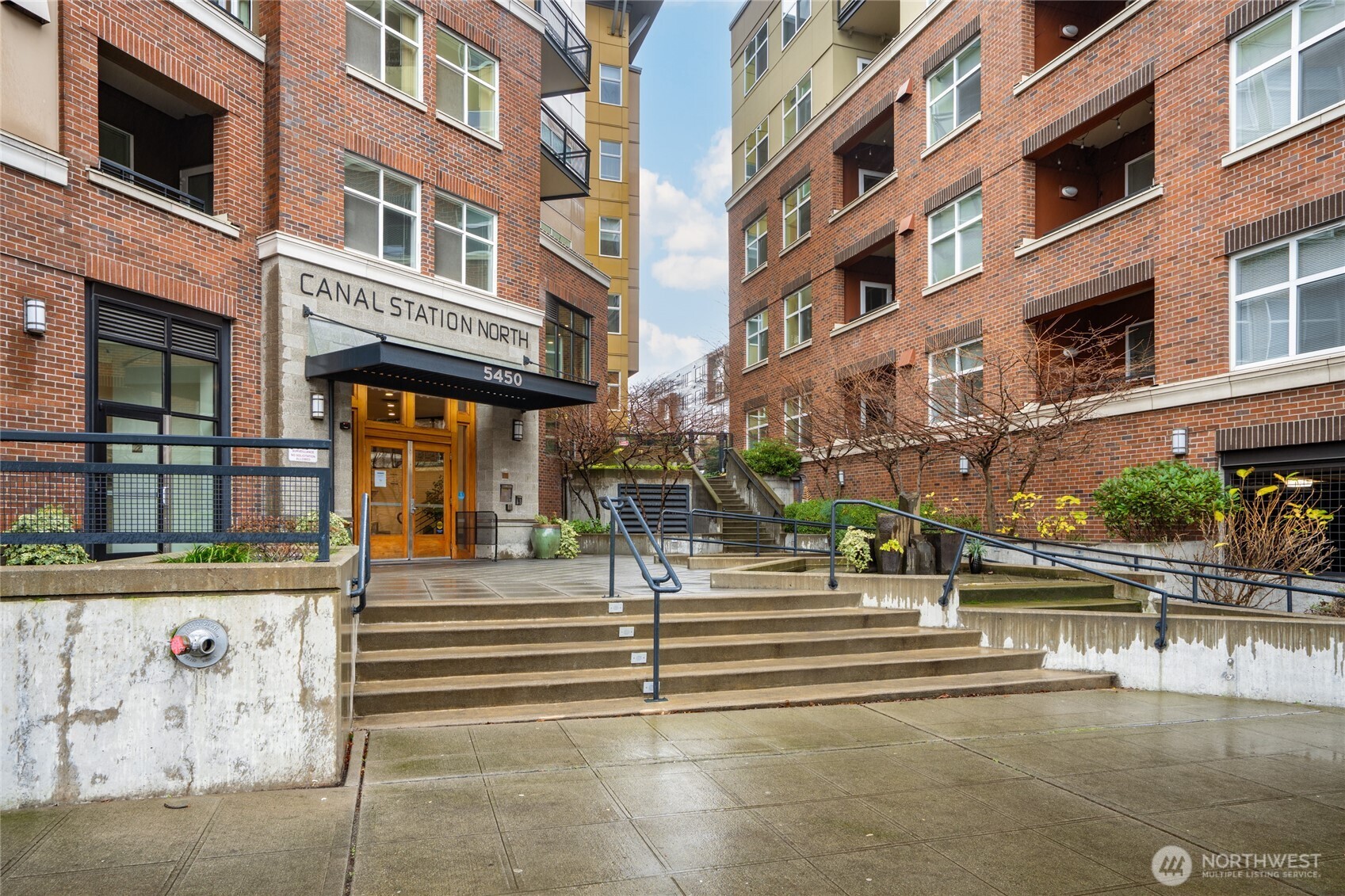 Live in the heart of Ballard, where historic charm meets vibrant city living. This desirable corner unit features a smart circular layout that lives larger than expected, with only one shared wall for extra privacy. It’s move-in ready with fresh paint & new carpet. The open kitchen showcases stainless steel appliances, granite counters, and generous prep space. Enjoy a private balcony, in-unit washer/dryer, secure parking, and bike storage. High-end bldg amenities include concierge, gym, sauna, hot tub, BBQs, and owner’s lounge. This well-managed, pet-friendly community has no rental cap, providing valuable long-term flexibility. Steps from coffee, bars, dining, shops, and the beloved Sunday Farmers Market. An exceptional lifestyle awaits!