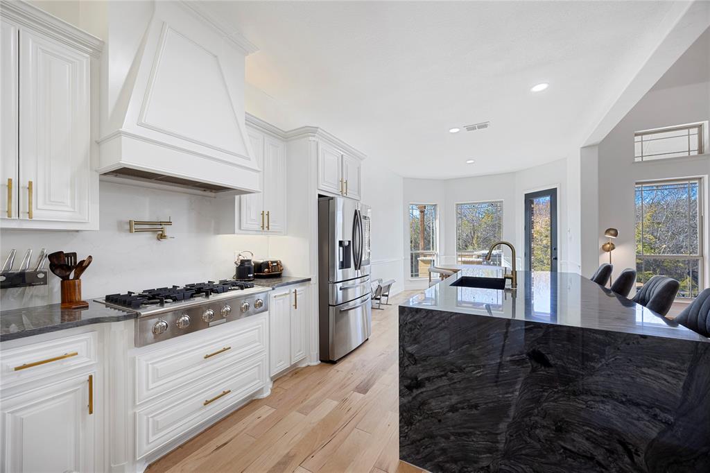 Nestled within the prestigious Canterbury Hills and backing onto a serene wildlife preserve, this remarkable 5-bedroom, 5-bathroom estate delivers an exceptional living experience in the heart of Trophy Club, Texas.Blending refined luxury with peaceful seclusion, the home is equally suited for everyday comfort and elevated entertaining. From the moment you enter, it’s clear this is somewhere special. The expansive open-concept layout showcases a beautifully renovated chef’s kitchen featuring a dramatic waterfall island, premium stainless-steel appliances, and generous counter space. Soaring ceilings and a striking fireplace feature wall anchor the main living area, creating an inviting setting for gatherings year-round.Outdoors, a private resort-style retreat awaits. Enjoy a custom pool and hot tub, two fire pits, outdoor TV, and a fully equipped kitchen ideal for al fresco dining. Surrounded by lush greenery and overlooking the preserve, you’ll often spot deer grazing just beyond your backyard. In warmer months, step directly onto scenic walking trails that lead toward the Grapevine Lake area.Inside, modern amenities abound, including a cinematic home theater with wet bar and LED mood lighting, a dedicated home office, a spacious game room with treetop and pool views, and a private home gym. The residence has been fully refreshed with brand-new high-end carpet, new floorboards, and a redesigned staircase, making it completely move-in ready.Just minutes from the Trophy Club golf course, 15 minutes from DFW Airport, and located within the highly regarded Northwest ISD, this home offers a rare balance of tranquility and convenience between Dallas and Fort Worth.This is a must-see property that won’t last long. Schedule your private showing today.