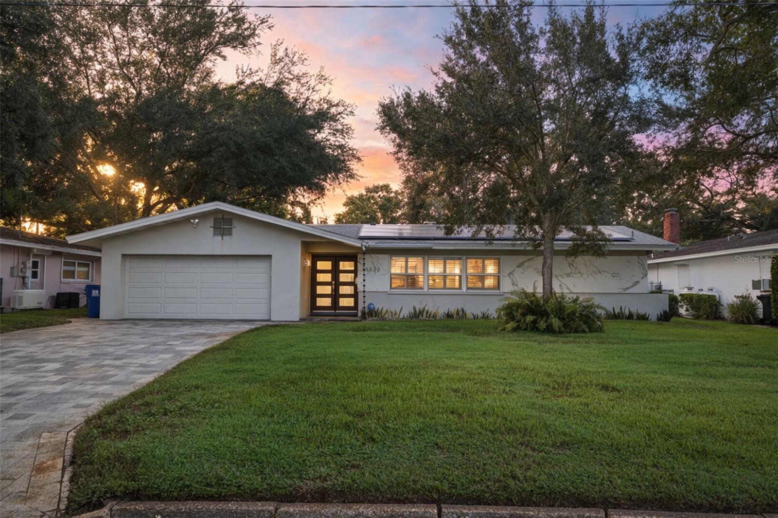 The truth is, homes like this don't come up often in Allendale — one of St. Petersburg's most premier neighborhoods. This mid-century modern ranch greets you with a striking Dekton stone exterior and a contemporary double-door glass entry, and what that means for you is a first impression that sets the tone for everything inside.  Just imagine living in a split floor plan that feels spacious, comfortable, and genuinely functional — with waterproof LVP/tile flooring flowing room to room, plantation shutters throughout, and custom touches you won't find in a typical build: stone-inlaid window sills, thick walls, and a level of upkeep that shows in every detail. The chef's kitchen brings solid maple cabinetry, granite counters and backsplash, and stainless appliances — built for real cooking, real entertaining, real life.The owner's suite is where it gets personal: a 10x9 walk-in closet with its own island (plus a brand-new 2025 custom closet system), and a spa-style bath with a jacuzzi tub and separate shower. How would you feel waking up to that every day?  Step outside and here's what's interesting — an oversized 22x19 patio with a built-in grill, made for the entertaining you've been putting off until "the right house." This might be it.  And the truth is, the value here goes beyond finishes. This home sits high and dry — no flood insurance required. Add a Tesla solar system with two Powerwalls, an integrated converter, and nine 7,200kW DC panels, and what that means for you is dramatically lower bills — plus the ability to run the entire house indefinitely during a storm outage, with no gap in power. The garage rounds it out with an epoxy floor, mini-split, and custom shelving, and a backyard shed adds even more storage.  Minutes to Downtown St. Pete, Tampa Airport, and the beaches — feel free to schedule your private showing before someone else does.