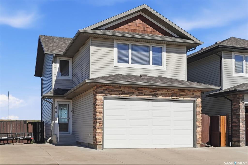 Beautifully Maintained 2-Storey Home Backing Green Space in Hampton Village! This fully developed 1,476 sq. ft. home offers a functional family-friendly layout, a double attached heated garage, and a large lot backing onto green space with plenty of parking. Located in the desirable Hampton Village area of Saskatoon, this home is close to schools, parks, walking paths, shopping, and numerous amenities.  The main floor welcomes you with a spacious foyer and an inviting open-concept layout featuring the living room flowing into the dining area and kitchen. The updated kitchen offers newer appliances, quartz countertops, an island, stylish tile backsplash, and ample cabinetry. A 2-piece bathroom completes the main floor.  The second level features a spacious bonus family room with a gas fireplace, three good-sized bedrooms, and a 4-piece bathroom. The primary bedroom offers his-and-her closets and a 3-piece ensuite, providing a comfortable private retreat.  The fully developed basement adds even more living space with a large open family room, 3-piece bathroom, laundry/utility room, and a versatile bonus area ideal for a home office, playroom, or additional storage.  Step outside to enjoy the large deck overlooking the fully landscaped and fenced backyard. The yard features underground sprinklers, two sheds, and plenty of green space, making it ideal for families and outdoor enjoyment.  Additional features include central air conditioning installed in 2019, central vacuum, natural gas BBQ hookup, all window coverings, and all appliances. A wonderful opportunity to own a well-cared-for home in a great Hampton Village location!  Call today to schedule your private viewing!