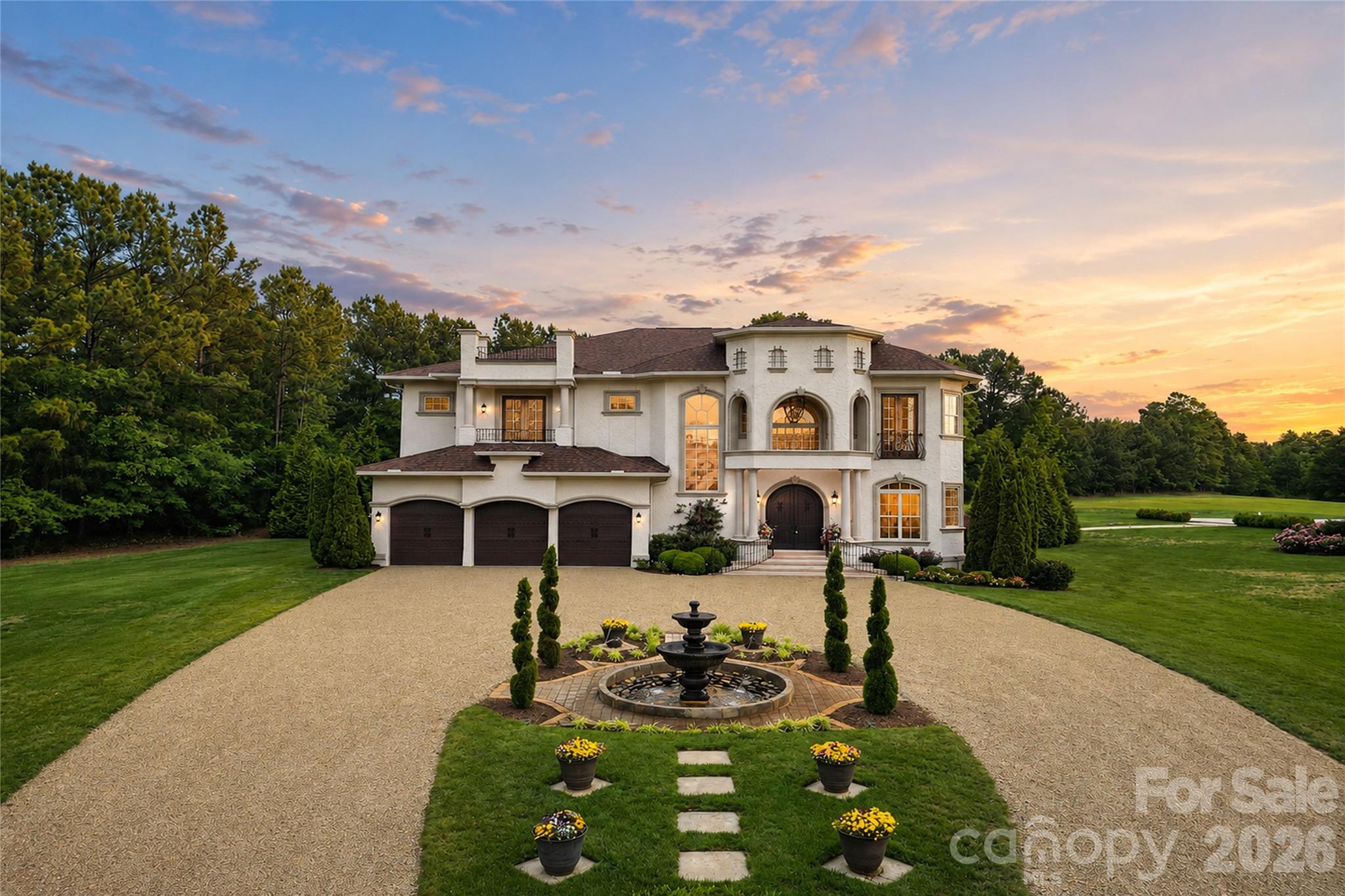 Set on more than 36 acres of rolling countryside, Belle Tesoro offers a rare opportunity to own a private estate designed for those who value space, seclusion, and control over their surroundings. Positioned just outside Spartanburg, the property delivers a level of privacy and scale that is increasingly difficult to find—where the approach itself, a gated and tree-lined drive leading to a circular motor court and fountain, immediately establishes a sense of arrival that is both refined and removed.The estate encompasses over 5,100 square feet of thoughtfully designed living space, where soaring ceilings, natural light, and custom millwork create an atmosphere of quiet sophistication. A dramatic sweeping staircase anchors the main level, complemented by a layout that balances everyday functionality with the ability to host and entertain with ease. The chef’s kitchen, formal dining room, and library provide structure and purpose to the home, while multiple fireplaces introduce warmth and character throughout. The primary suite serves as a true private retreat, featuring a spa-style bath, private balcony, and elevated views across the surrounding landscape.Outdoor living is equally intentional. Covered verandas and expansive patios extend the home into a resort-style setting, centered around a pool and fountain framed by manicured grounds and mature landscaping. Beyond the immediate homesite, the acreage opens into a blend of cleared pasture and wooded privacy, offering flexibility for a range of lifestyle uses—from recreational enjoyment to agricultural pursuits (see tax records for land designation).For buyers seeking a property that prioritizes privacy over proximity and land over density, Belle Tesoro represents a compelling alternative to traditional luxury offerings. It is a residence defined not only by its architecture, but by the freedom and space it provides—an estate environment designed for long-term living, personal vision, and a level of separation that cannot be replicated in more conventional settings.