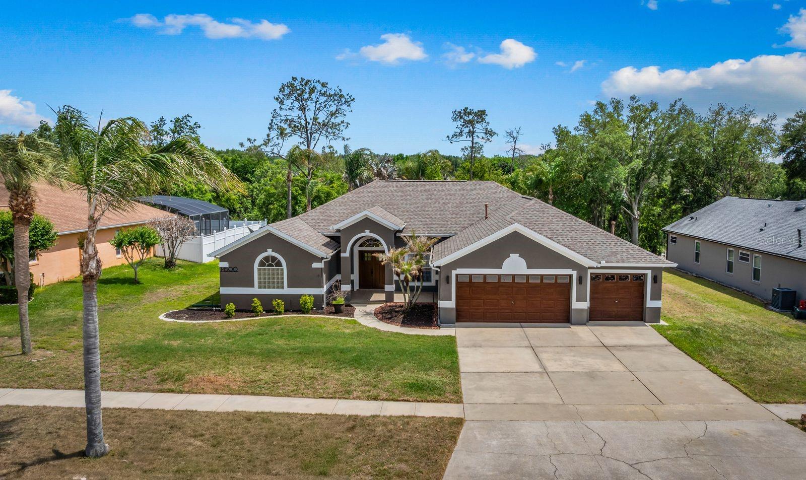 One or more photos have been virtually staged. Welcome to this exceptionally clean and well-maintained 4-bedroom, 3-bath single family Home with newer solar panels-owner owned, saltwater pool/water fountain, 3+ car garage, situated on an oversized lot backing to a serene open pine tree forest backyard views on the other side of the property line giving a breathtaking view of nature,  with privacy and no rear neighbors in your back yard. This home offers excellent curb appeal, a desirable split-bedroom layout, and a spacious open floor plan with a large family room, breakfast nook, and well-appointed kitchen. Energy-conscious buyers will appreciate the owner-owned solar panels, septic system, and wood-burning fireplace, helping support lower monthly utility costs. Owners can show low historical Utility bills.From the moment you arrive you will see the stunning curb appeal and new modern front door with great presence.  Inside, you will see it’s thoughtfully designed, with friendly floorplan, plenty of built-ins, fresh simple paint finishes inside, with upgraded lighting & light fixtures and more. Nice presentation into home from large foyer.  See the back of the house from the front door. Recent custom built-in office/den area room created for room for 2 desks with French doors leading outside to the pool area with oversized deck extending full size of back of home with large, fully screened enclosure. A formal dining room is at front of home. The private primary suite is tucked away on the left side with this split floor plan, while 3 additional bedrooms are positioned on the opposite, right side of home. The primary suite offers dual vanities, a garden tub, separate shower, and walk-in closets. 3 Full sized Bathtubs in all bathrooms. Enjoy the natural sunlight shining throughout the main living areas throughout the kitchen, dining/breakfast nook and large living Room with wood fireplace, overlooking pool views with plenty of windows and doors for flexible indoor/outdoor living and entertaining.  New Appliances just arrived, stone counters, maple wood veneer finish cabinets and a well-equipped kitchen complete with kitchen island, walk-in kitchen pantry, built-in desk.This home has been lovingly updated by owners over 7years. Other upgrades & renovations include a complete new roof, newer owner-owned solar power on roof, newer A/C & solar water heater, new front door, 2 new rear doors, new range, refrigerator, washer, and dryer, updated bathroom vanities, mirrors, and lighting, newer ceiling fans, 3 newer comfort-height toilets, recently added luxury vinyl flooring, fresh interior paint, and a recently actived water softener system. The exterior has also been recently painted. All appliances will convey with the Home, including a refrigerator in the garage and a fixed TV on the outside wall at back patio. The septic system was recently cleaned for added peace of mind. 3+ Car Garage with extra depth, with some room on both sides, attic storage, and plenty of room for vehicles, toys & storage.  3 car width driveway provides ample parking for multiple vehicles.Conveniently located approximately 30 minutes from Orlando with easy access to Highway 50 and the Florida Turnpike, and within 3 miles of K-12 schools, Lake-Sumter State College, hospitals, shopping, and dining.  Home is being sold As-Is.