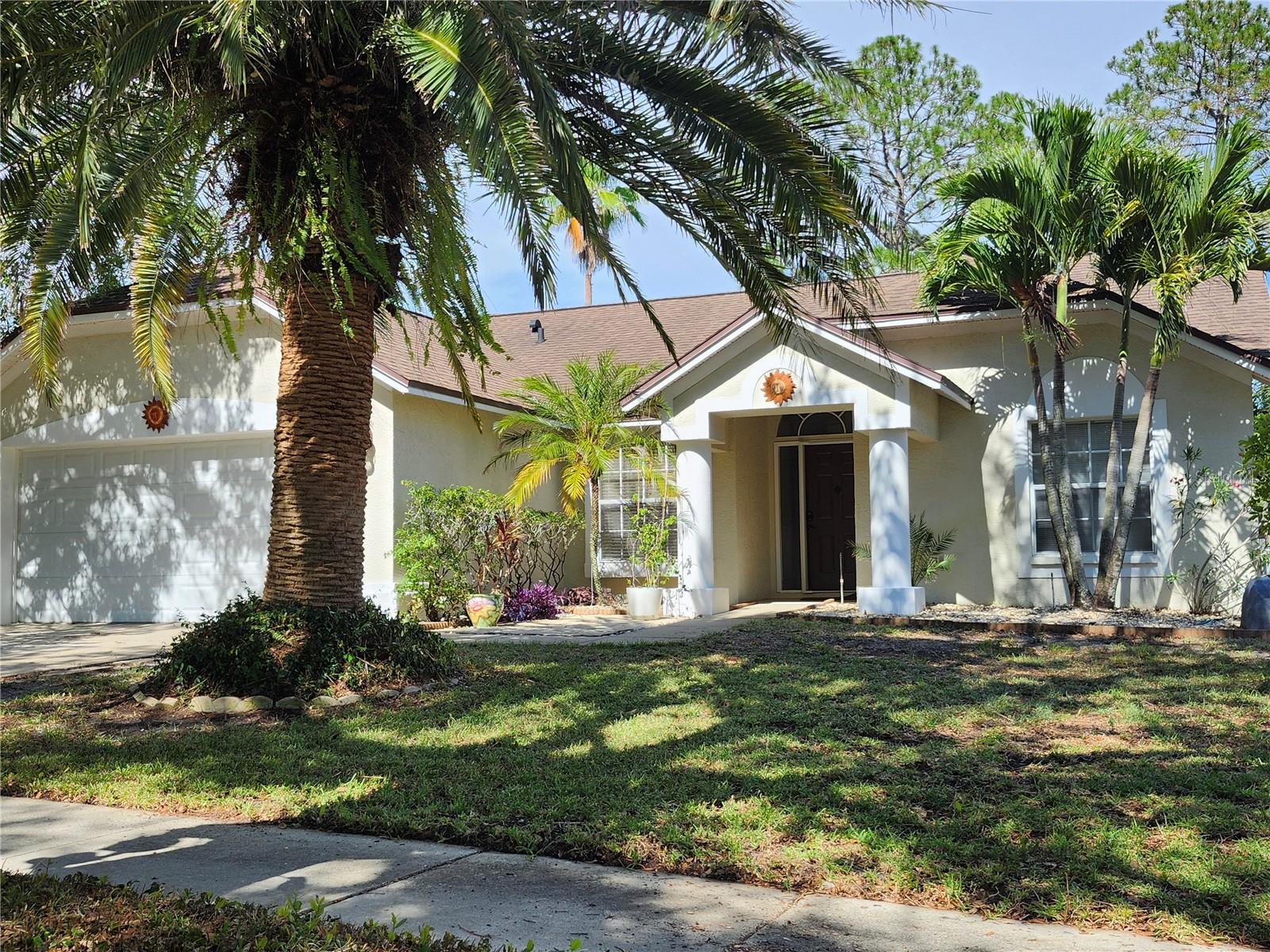 WOW! Incredible value on this beautiful move-in-ready home, priced thousands below comparable properties. The motivated seller has already upgraded the home with a brand-new 2026 HVAC system featuring a transferablewarranty for added peace of mind. Step inside to discover a spacious, light-filled floor plan with soaring ceilings, freshinterior paint, three bedrooms, and a 2-car garage. Stunning Brazilian Cherry hardwood floors are scheduled to beprofessionally refinished June 22–24, enhancing the home's warmth and elegance. The bright white kitchen offersnewer stainless steel appliances and a cozy breakfast nook. Additional recent improvements include anew roof in 2016,  a new water heater installed in 2025, and the irrigation well, replaced in 2024, powersthe Rain Bird sprinkler system to maintain a lush landscape while reducing city water usage and saving hundredsof dollars annually on water bills.  Enjoy outdoor living on the attached screened porch overlooking a serene, fencedbackyard, perfect for relaxing or entertaining. Located in the highly desirable Beckett Bay community within the Cityof Tarpon Springs and X Flood Zone, this home offers exceptional amenities, including a community pool, tennis and basketball courts,picnic area, and playground. Enjoy a short bike ride to the world-famous Sponge Docks and charming downtownTarpon Springs.