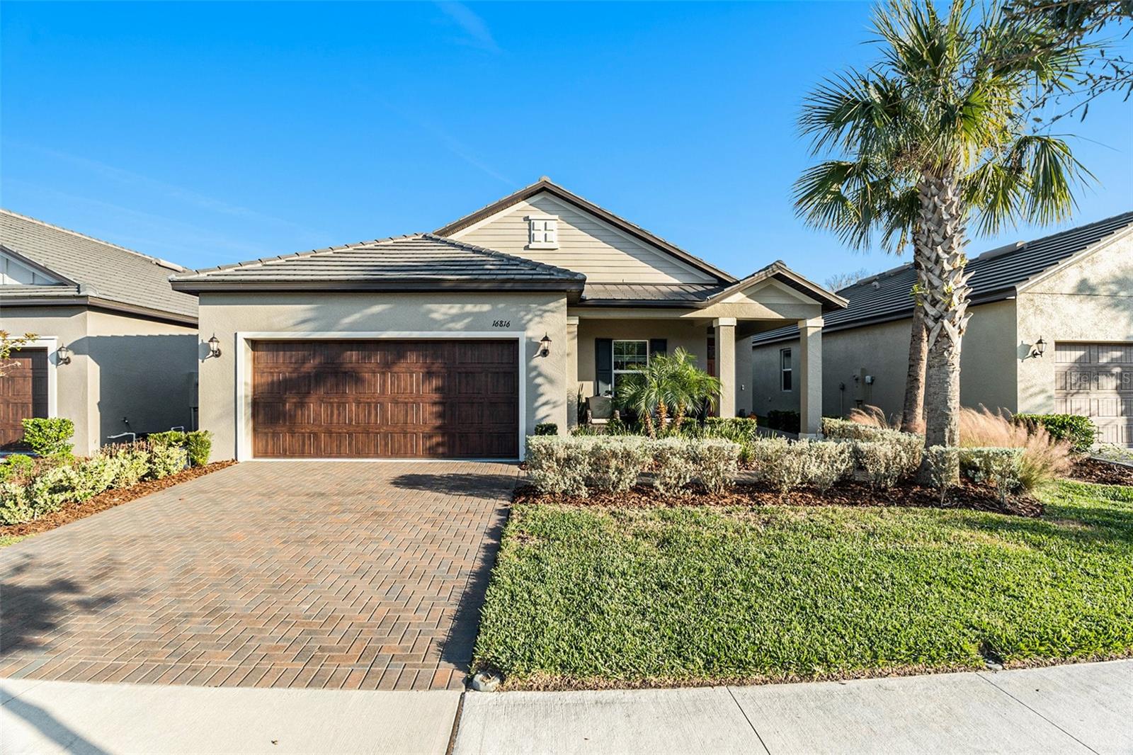 This Move-In Ready Home in Angeline is a highly sought-after Active Adult premier 55+ master-planned community ! This modern 2-bedroom, 2-bath home with a versatile flex room offers the perfect blend of comfort, function, and style. Just off the foyer, the flex space can serve as a home office, hobby room, or guest retreat. The open-concept layout connects the fully equipped kitchen, dining room, and family room, all leading to a large screened-in patio with peaceful natural views. With no backyard neighbors, mornings and evenings are ideal for enjoying tranquility and nature's beautiful creatures. The private owner’s suite features a spacious bedroom and a generous en-suite bathroom with dual sinks, a large walk-in tiled shower, and a water closet. Upgrades include stainless steel appliances, quartz countertops, ceramic tile flooring, crown molding throughout, and an upgraded super-quiet dishwasher. A dedicated laundry room, 2-car garage with additional golf cart space, and fully fenced yard provide extra convenience and privacy. The community offers exceptional amenities, including a private, multi-million-dollar resort-style amenity center just a short walk away, complete with a pool, sports courts, and clubhouse. Residents enjoy over 100 miles of walking, jogging, and biking trails, a future recreational lagoon with acres of crystal-clear water, 3,600 acres of preserved green space, a community farm, and endless outdoor activities that make Angeline an active adult haven. Coming soon: a new Moffitt Cancer Center facility nearby, adding even more convenience and peace of mind for residents. Schedule your private showing today and be in your new home before Christmas.