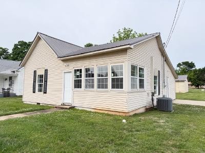 Charming in-town starter home featuring a 2-car detached garage, new windows, fresh paint, and a metal roof. Efficient layout with comfortable living space and great natural light. Level lot with usable outdoor space. Centrally located near shops and dining.