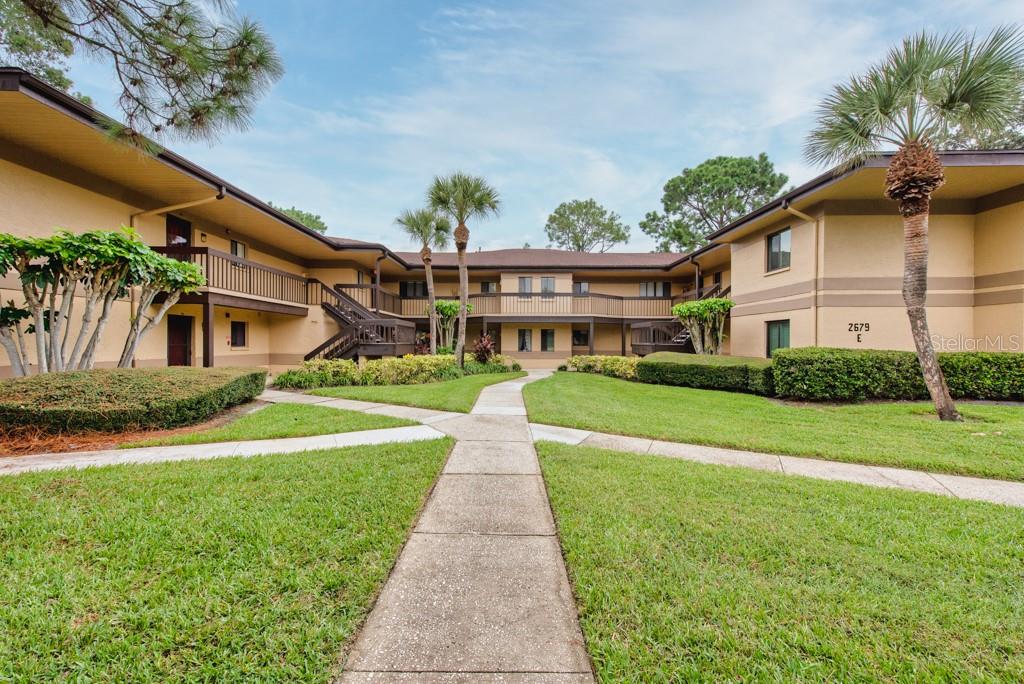 Lush greenery, serene pond views, and the comforts of modern updates define this spacious first-floor condo at 2679 Sabal Springs Circle, Unit 102, Clearwater, FL. With 2 bedrooms, 2 bathrooms, and 1,100 sq. ft. of living space, this home is tucked into one of Countryside’s most desirable communities in Pinellas County. Step inside to find thoughtful upgrades totaling nearly $7,000–$10,000 over the past year and a half. A bright, open living area flows to a flexible back alcove and patio surrounded by mature trees and landscaping—perfect as a home office, reading nook, or even an extra guest space. The kitchen features stainless steel appliances, a side-by-side refrigerator, pendant lighting over the breakfast counter, and plenty of cabinet storage. Recent updates include a new microwave, a new electrical panel (2022), and a hot water heater installed less than 4 months ago with a transferable 6-year warranty. The oversized primary suite offers an ensuite bath with a soaking tub and a large closet, while the guest bedroom provides comfortable space with generous storage. Both bathrooms shine with new toilets and modern dimmable lighting. Throughout the home, you’ll find new ceiling fans with remotes, stylish lighting, and well-maintained systems, including AC, heat, and plumbing in excellent working order. Outside, enjoy a tranquil setting with views of the pond and gazebo, plus access to resort-style amenities including a community pool, tennis courts, and covered parking with additional guest spaces. Located just minutes from Westfield Countryside Mall, shops, restaurants, parks, schools, and world-famous Gulf beaches, this condo pairs convenience with relaxation. Monthly maintenance is $566.66, covering community features and upkeep for worry-free living. Call now and schedule your viewing today!