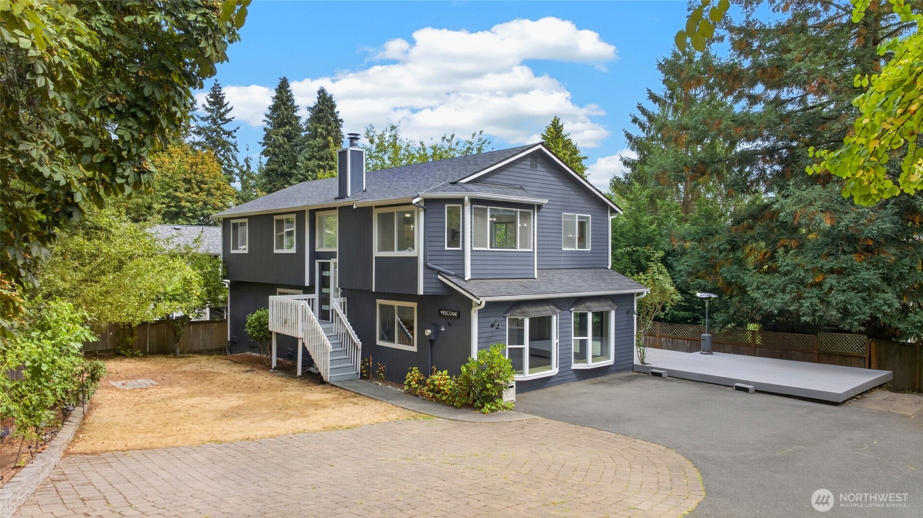 Need space, parking and flexibility? This one is different! Extensively updated 5-bedroom North Seattle home on an expansive 8,905 SF lot with a gated private driveway and exceptional off-street parking. Major improvements include a newer roof and exterior paint, along with updated flooring, interior paint, doors, lighting and bathrooms. The refreshed main kitchen shines with white cabinetry, quartz surfaces, stainless appliances, farmhouse sink and coffee bar. The thoughtfully converted garage provides additional finished living space with a second kitchen and flexible gathering area, creating excellent possibilities for multigenerational living, guests, work-from-home, hobbies, or recreation. Looking for even more space? An expansive crawlspace accessible from the stairway closet offers exciting potential to create approximately 1,000 SF of additional basement space. Bring your vision and explore the possibilities! Outside, the gated driveway creates a private setting with room for multiple cars, work vehicles and toys, while the oversized deck offers plenty of space to entertain and enjoy the outdoors. Close to Jackson Park trails and golf, shopping, dining, transit, Northgate light rail and commuter routes. Updated, versatile and move-in ready with a combination of space and parking that's increasingly hard to find in Seattle.
