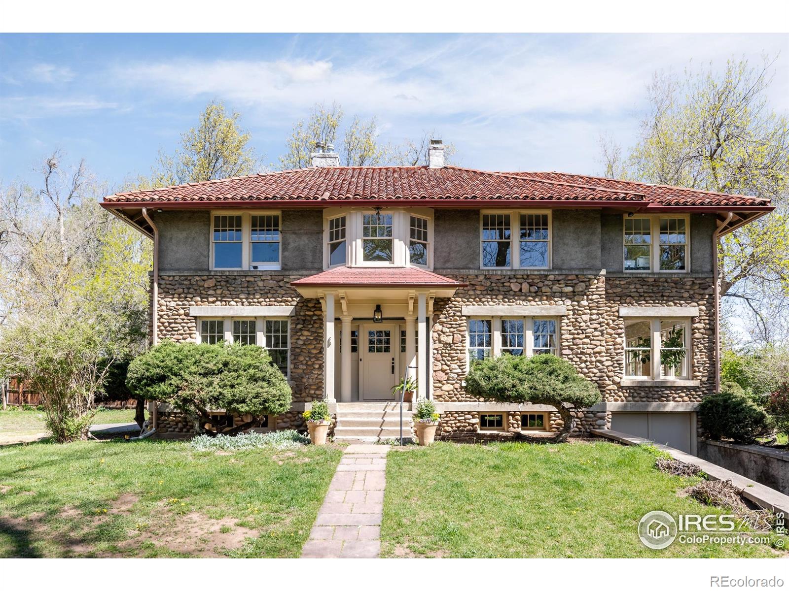 Steeped in history and nestled on over half an acre in the heart of Old North Boulder, this beloved property is set back from the street in a serene, tree-canopied enclave. The Bartlett House combines timeless architecture with rare development potential. Built in 1917 and landmarked in 2016, this property has a storied past tied to several of Boulder's most notable figures Fred Tyler, Lu Monroe, and Albert Bartlett. With sun-drenched sitting rooms and ample living space, the residence balances historic charm with compelling opportunity. Current permits allow for thoughtful enhancements including a new living room, two-car sunken garage with terrace above, a 500-square-foot ADU, a reimagined open kitchen and dining space, plus a swimming pool and outdoor entertaining area. Whether you choose to personalize the existing home or execute the ready-to-go design plans, the groundwork for transformation has been expertly laid. Just minutes from the Pearl Street Mall, Ideal Market Plaza, and North Boulder trails, this property offers rare proximity to both vibrant city life and peaceful natural surroundings-all within one of Boulder's most sought-after neighborhoods.