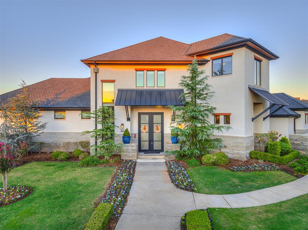 Experience refined lakeside living in this exceptional contemporary home nestled on a coveted waterfront lot in the gated Cypress Point community. Set at the end of a cul-de-sac, this stunning 5-bedroom, 4.1-bath residence offers approximately 5,491 SF of thoughtfully designed living space with beautiful water views and impressive indoor-outdoor living. The dramatic entry opens to spacious living areas, soaring ceilings, and abundant natural light. The gourmet kitchen is a true centerpiece, featuring a large island, premium appliances, built-in refrigerator/freezer, and a 6-burner gas range—perfect for both everyday living and entertaining. The main level offers generous living and dining spaces, along with a luxurious primary suite designed as a private retreat. Upstairs, additional bedrooms and living areas provide exceptional flexibility for family and guests. Step outside to enjoy the private courtyard, covered patio, pool, and sweeping waterfront setting. Additional highlights include a 3-car attached garage, security system, underground sprinkler, double-pane windows, and an elegant combination of stone and brick exterior. Located in the sought-after Edmond school district, this remarkable home delivers privacy, sophistication, and resort-style living in one unforgettable setting.