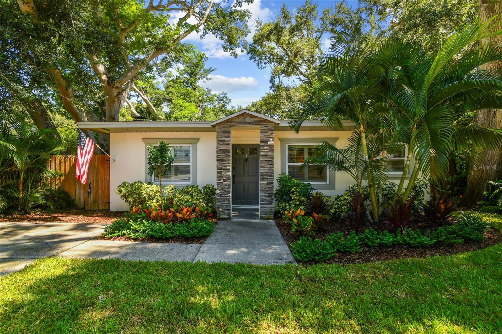 Welcome to 3215 W. Villa Rosa Street, a thoughtfully updated residence nestled on a tranquil, tree-lined street in the heart of Bayshore Beautiful—one of Tampa’s most sought-after neighborhoods. This charming 2-bedroom, 1.5-bath concrete block home is completely move-in ready and located in Flood Zone X, eliminating the need for flood insurance and offering peace of mind with no history of flooding. Inside, you’ll find a welcoming interior featuring impact windows (installed in 2017), recessed lighting, fresh interior paint, granite countertops, updated fixtures, and plantation shutters. The electrical wiring was also updated in 2017, ensuring safety and reliability. A wood-burning fireplace adds warmth and character to the living space, while the solid block construction—including interior walls—helps keep the home cooler and quieter year-round. Additional closets throughout add additional storage, perfect for organizing household essentials.
The exterior is equally impressive, with a 2017 roof and a recently repaired flat roof section, plus new sod and landscaping that enhance curb appeal. In addition to the driveway, there is also a shell parking pad. A fully functioning irrigation system keeps the yard lush and green with minimal effort. The spacious, fully fenced backyard offers room to roam, a barn-style storage shed, and endless potential for outdoor living. Located just North of Gandy Boulevard, this home provides exceptional walkability to Bayshore Boulevard, a newly renovated Publix, top-rated dining, the South Tampa Family YMCA, and recreational amenities like tennis courts and baseball fields. With quick access to the Selmon Expressway, downtown Tampa, MacDill Air Force Base, and the Gandy Bridge, convenience meets charm in this turnkey property. Schedule your private showing today and experience the best of South Tampa living.