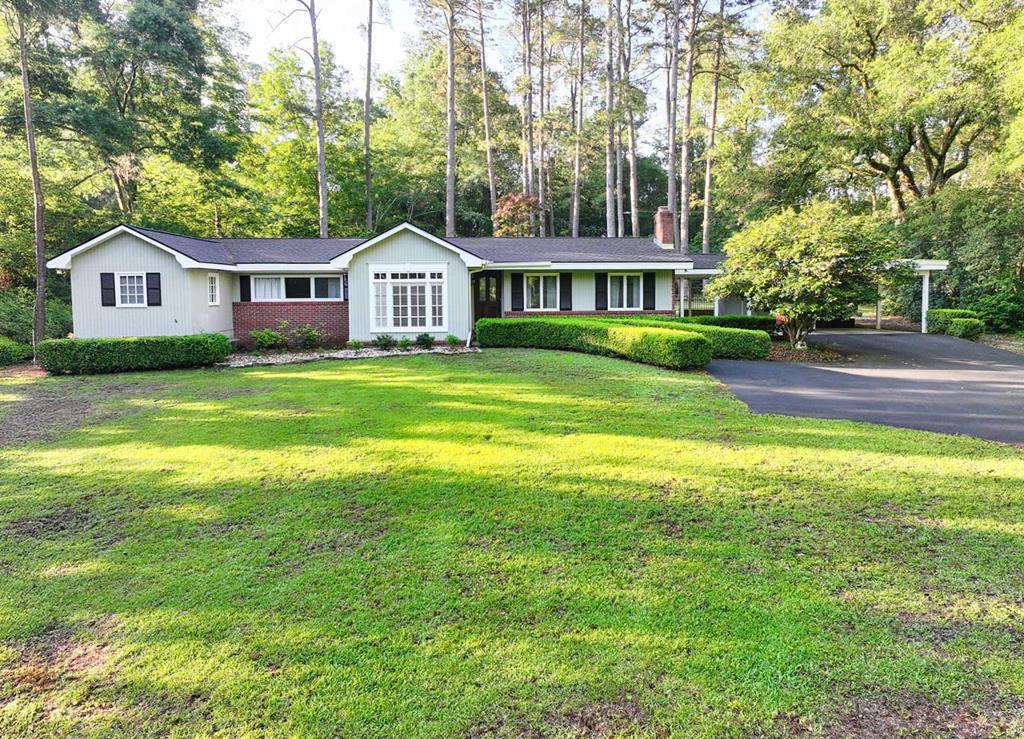 Completely updated and move-in ready, this beautifully improved property offers the perfect blend of modern upgrades, privacy, and location. Major recent improvements include a brand NEW roof, NEW flooring throughout the home, a completely renovated kitchen with NEW cabinetry, countertops, and appliances, as well as a NEW tankless water heater. These significant updates provide both style and peace of mind, allowing buyers to enjoy the home without the expense and stress of tackling major projects after closing. Situated on over an acre in one of Thomasville's most desirable in-town locations, this property offers a setting that is becoming increasingly difficult to find. Located just around the corner from Glen Arven Country Club and only minutes from downtown Thomasville, the home combines convenience with a level of privacy rarely available this close to town. The property backs up to adjoining plantation land, creating a quiet, scenic backdrop with beautiful natural surroundings and a peaceful atmosphere that feels far removed from the city while still keeping you close to shopping, dining, schools, and entertainment. Inside, the home features warm and inviting living spaces filled with natural light and views of the surrounding property. The renovated kitchen serves as the centerpiece of the home with updated finishes and a fresh modern feel, while the spacious living areas provide comfortable everyday living and excellent entertaining space. The expansive lot offers endless possibilities for outdoor enjoyment, whether relaxing in the privacy of your backyard, hosting gatherings with family and friends, gardening, or simply enjoying the open space and mature surroundings. Properties with over an acre, extensive updates, and this type of location near Glen Arven and downtown Thomasville rarely become available. 123 W Club Drive offers a unique opportunity to enjoy updated in-town living with space, privacy, and a setting that truly stands apart from the typical neighborhood home.
