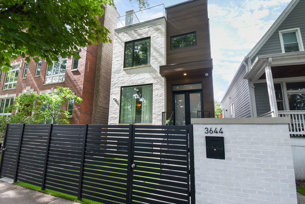 This stunning single-family home in Southport Corridor, crafted by an established builder and professional designer, showcases luxury and attention to detail throughout. The main floor is perfect for entertaining, featuring a rare open layout, an expansive kitchen with a large island, and plenty of natural light. The second floor boasts an en-suite bedroom and a magnificent master suite with dual walk-in closets, separate vanities, a soaking tub, a steam shower, heated floors, and a dressing room with laundry. The third floor offers a spacious flex area with a wet bar, a full bath, and access to two outdoor spaces. The lower level includes radiant floors, a rec room with a wet bar, a generous office/bedroom, a powder room, and a guest bedroom with a walk-in closet and bathroom. Outdoor living is a dream with a back patio, a wood-burning fireplace, and a garage rooftop deck. Just a block from Juniper Play Lot and minutes from shopping, restaurants, the L, and Whole Foods.
