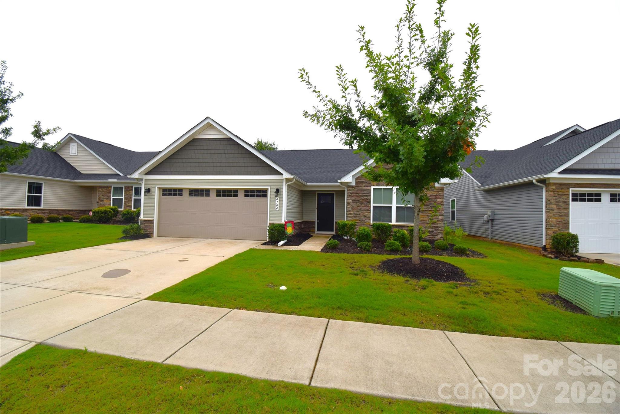 Come check out his well cared for ranch located near Belmont & the White Water Center. Lawn maintenance & care is provided & paid for w/your modest monthly HOA dues. Open plan features large kitchen w/island, quartz countertops, & SS appliances. Convenient dining area opens to a 12x10 patio. The home backs up to a wooded area that is owned by the HOA and adds to privacy & quiet enjoyment in the backyard, with no homes behind. Great room is open to kitchen & features beautiful, vinyl plank flooring. The split floor plan creates privacy with the primary bedroom suite and secondary bedrooms on opposite ends of this home. The primary suite features a nice walk-in closet & spacious bath with a double vanity and a nice ceramic tile shower. Secondary bedrooms feature large closets and a hall bath with a shower tub combo. The double garage features two bays, one is extended and can fit a full size SUV, or pick-up. Located near to charming Belmont, convenient to the airport, major interstates and shopping. Buyer or Buyer agent to verify schools