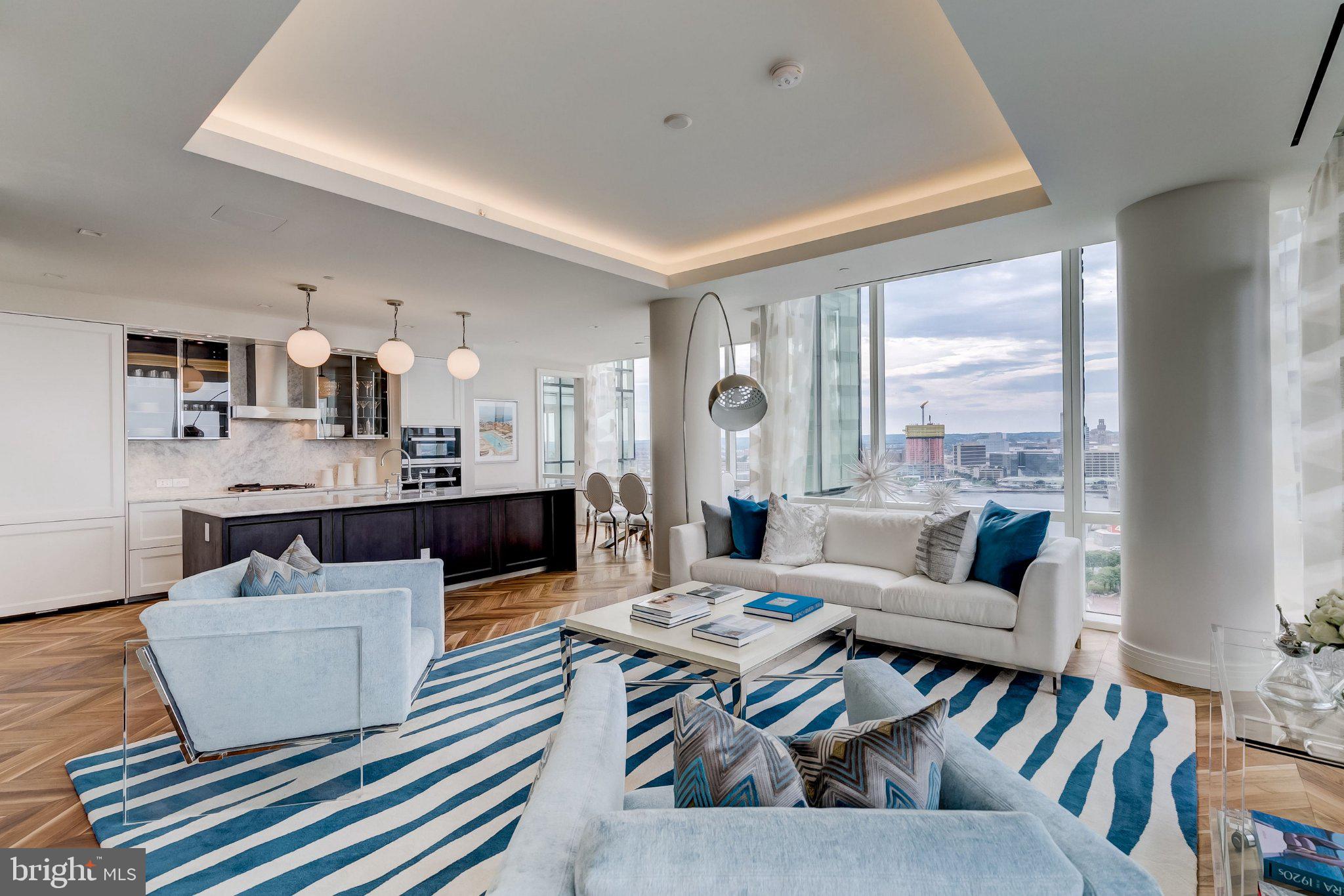 Welcome to the Four Seasons Private Residences, where luxury and location converge. In Baltimore's vibrant Harbor East, you’ll find this gorgeous 2-bedroom, 2-full-bathroom unit on the 20th floor that offers spectacular views of the Inner Harbor, marina, and city skyline through floor-to-ceiling windows.  Step outside on the balcony for morning coffee or a relaxing evening and enjoy the views.  The open layout brings in natural light throughout the unit, complementing the walnut chevron floors. The gourmet kitchen features a suite of Miele appliances, elegant cabinetry, a gas cooktop, wall oven, a huge island, quartz countertops, and a beverage fridge. The primary suite includes a walk-in closet and a bathroom retreat with double sinks, a large soaking tub, and a separate shower.  All windows come with automatic shades, and the bedrooms include black-out shades as well. The second bedroom is perfect for guests, family, or as an inviting workspace.   All tenants have exclusive access to the private 28th-floor amenity level, featuring an indoor saltwater infinity pool, sauna, outdoor deck with grilling station, fitness center,  billiards table, kitchen and dining areas, conference space, and a dog-walking area. The 28th floor outdoor decks offer incredible views of the skyline and Baltimore’s busy harbor.     Tenants also have access to Four Seasons hotel amenities, including in-house dining, housekeeping services, pet care services, the hotel pool, fitness center, spa, valet services, exclusive access to hotel events, and much more. A private, secure residents-only lobby ensures a safe and comfortable environment for everyone.     This unit comes with 1 dedicated parking space and 1 storage unit. The Four Seasons features 4 on-site restaurants, with many more exceptional dining options just a short walk away in Harbor East and Fells Point. Shopping, parks, harbor activities, museums, and miles of scenic waterfront walkways are all close enough to enjoy every day - and, of course, the Orioles' and Ravens' stadiums are also nearby. Experience relaxed luxury at the Four Seasons - it's more than a residence, it's a lifestyle.