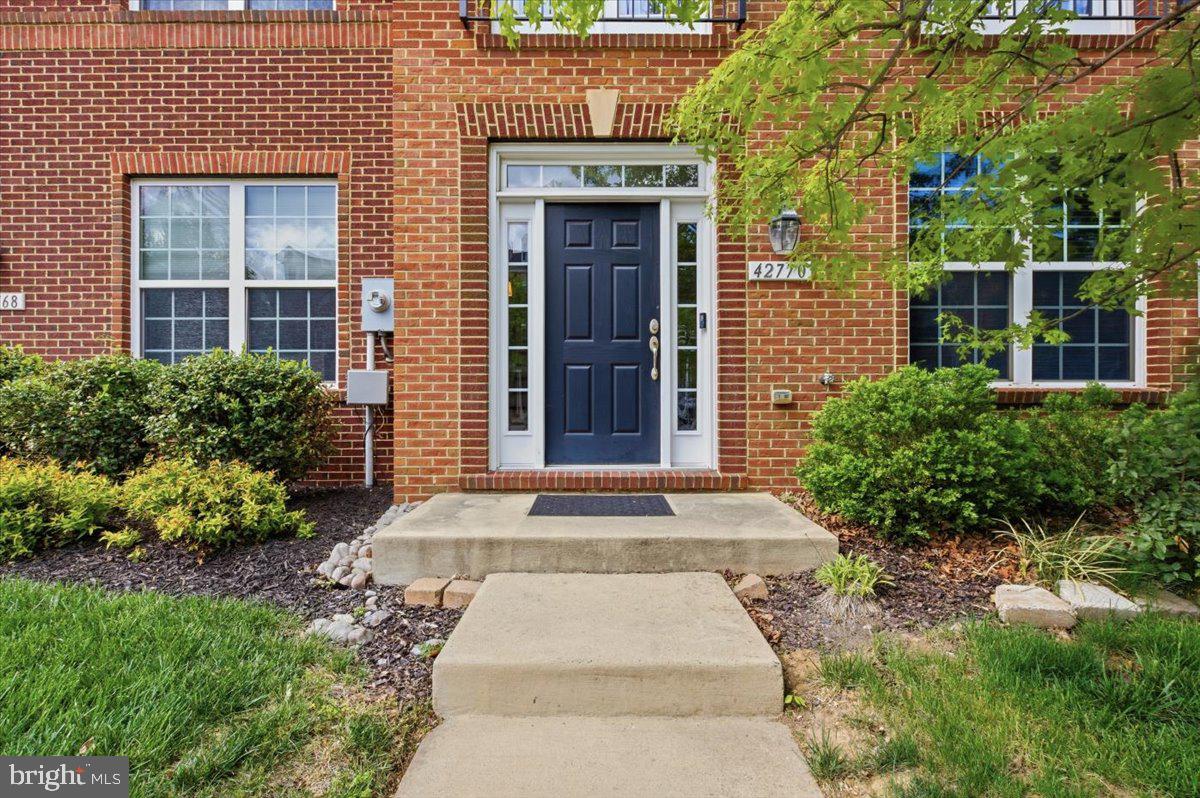 Welcome to Goose Creek Village, where style, space, and convenience come together in this beautifully updated 3 bedroom, 2 full bath, 2 half bath townhome. Thoughtfully designed for modern living, this home features refinished hardwood floors, custom built ins, and a bright open layout ideal for both everyday comfort and entertaining.The entry level offers a spacious foyer leading to a large family room, perfect for a home office, gym, playroom, or additional living space, along with a convenient half bath. Upstairs, the main level is filled with natural light and offers seamless flow between the living room, dining area, and gourmet kitchen. A striking multi sided fireplace creates warmth and character while defining the space.The kitchen is a standout with granite countertops, shaker style cabinetry, sleek appliances, and a center island perfect for meal prep and gathering. Just off the dining area, step onto the expansive full width balcony, ideal for grilling, relaxing, or enjoying your morning coffee. A second half bath completes the main level.Upstairs, the spacious primary suite features abundant natural light, a walk in closet with custom built ins, and a private bath with double vanity. Two additional generously sized bedrooms share a well appointed hall bath, and the laundry is conveniently located on the bedroom level.Additional highlights include a large 2 car garage, driveway parking, and extra storage space. Residents enjoy outstanding community amenities including an outdoor pool, parks, playgrounds, and walking trails.Ideally located just steps from Goose Creek Village Center with Harris Teeter, Walgreens, shops, dining, and everyday conveniences. Minutes to Belmont Station Elementary, Trailside MS, and Stone Bridge HS, multiple golf courses, outdoor recreation, Route 7, the Dulles Greenway, and Dulles International Airport.