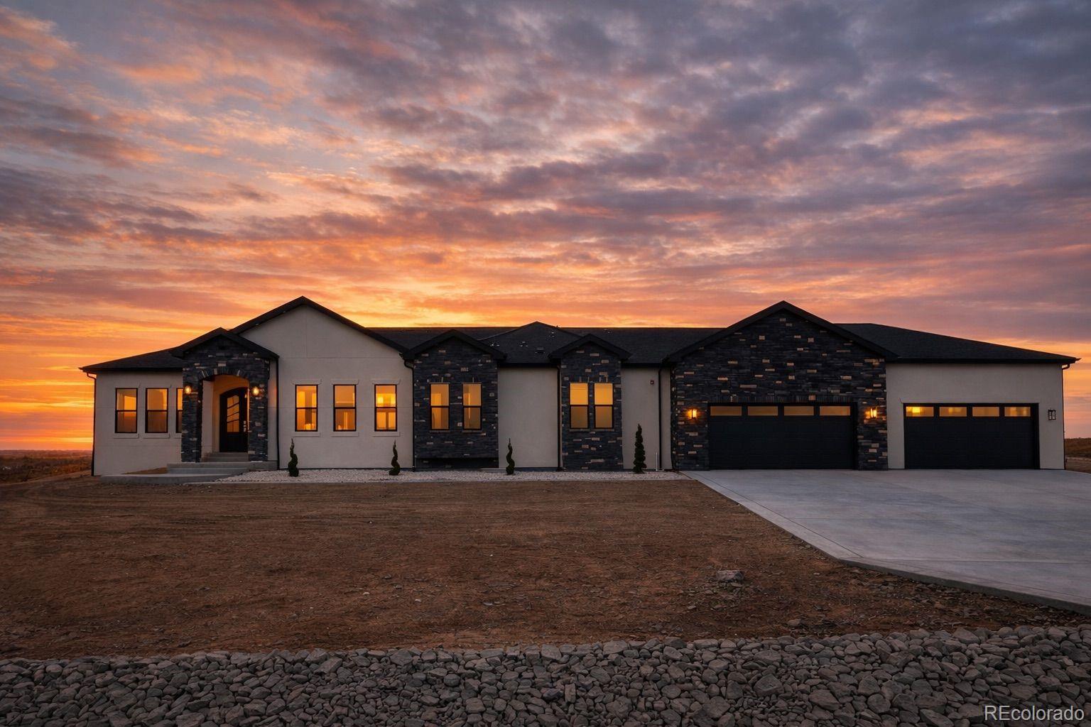 Experience the rare blend of modern luxury and Colorado ranch living in this exceptional new-construction residence, thoughtfully designed for those who value space, comfort, and intentional living. Set on a generous lot within a peaceful ranch-style community, this home offers the freedom of open surroundings with the convenience of nearby city access. From the moment you arrive, the striking modern elevation and covered porches invite you to slow down and enjoy the setting. Inside, expansive windows and soaring ceilings fill the open-concept layout with natural light, creating an effortless flow between the great room, dining area, and chef-inspired kitchen, ideal for both intimate moments and memorable gatherings. A statement fireplace anchors the living space, adding warmth and character year-round. The main-level primary suite is a true retreat, offering privacy, comfort, and a spa-like bath designed for relaxation at the end of the day. Additional main-floor bedrooms and a dedicated office provide flexibility for family, guests, or working from home. The fully finished basement extends the lifestyle even further, featuring multiple bedrooms and baths, an entertainment space, bar area, gym, and room to host, unwind, or create a multigenerational living environment. Every space has been designed with purpose and ease in mind. A rare four-car garage offers abundant room for vehicles, storage, and recreation, perfect for those who embrace an active Colorado lifestyle. Surrounded by wide-open skies and a sense of breathing room, this ranch-style neighborhood offers a peaceful escape while remaining minutes from Brighton's shopping, dining, schools, and commuter routes to Denver and DIA. This is more than a home, it's a place to live expansively, gather meaningfully, and enjoy the luxury of space, both inside and out