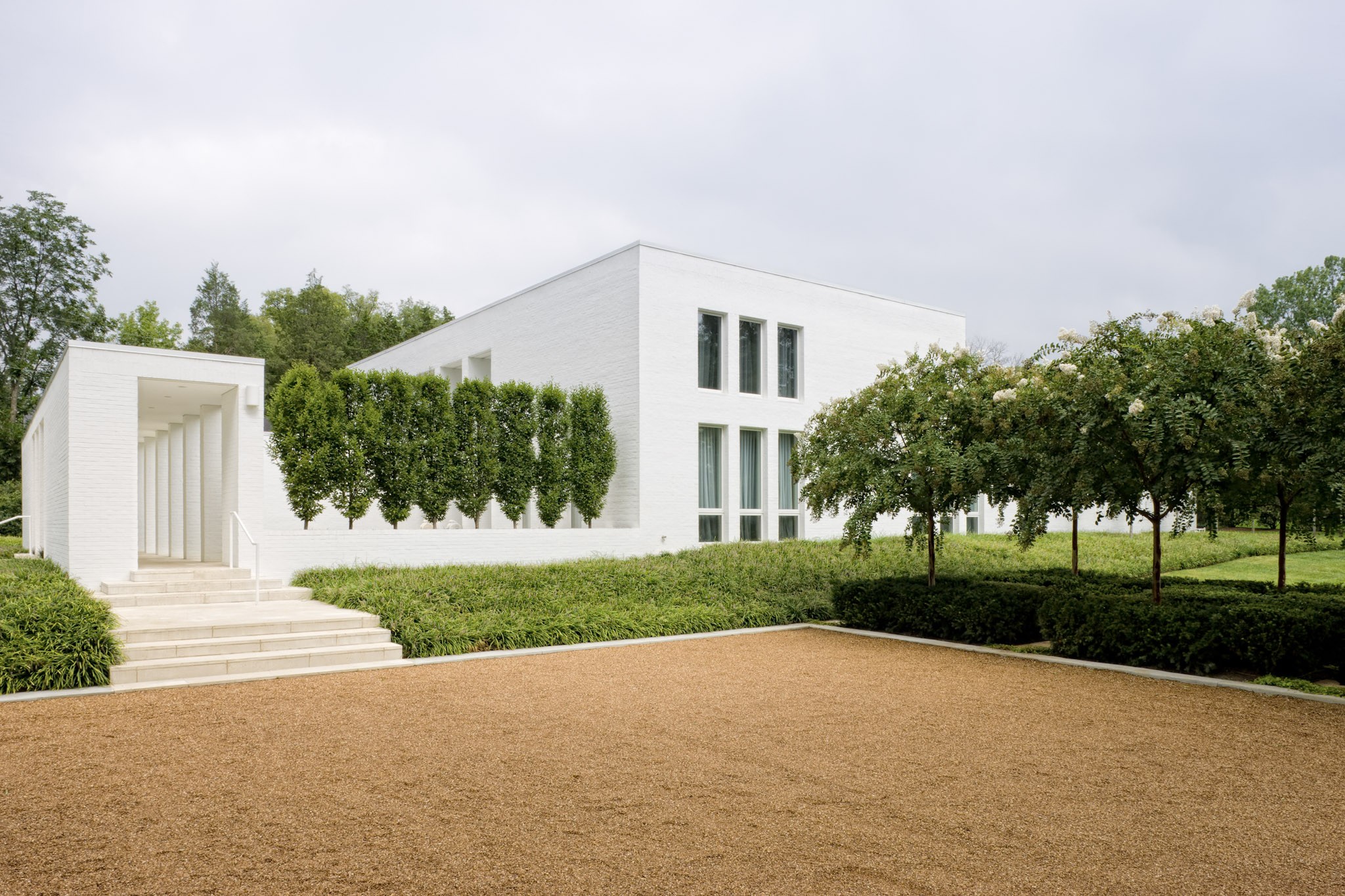 Bold in architecture, exceptional in execution, and unmistakably original, 734 Jackson Boulevard makes an extraordinary contemporary statement among the traditional estates of Belle Meade. Set on 1.4 level acres in the heart of Belle Meade, this exceptional estate offers a rare combination of architectural distinction, privacy, and proximity to two of Nashville's most treasured destinations, Percy Warner Park & Belle Meade Country Club. A singular vision brought together by three respected names in design: Larry Woodson of Woodson Gilchrist Architects, Mike Kaiser of Kaiser Trabue Landscape Architects, and interior designer Katy Chudacoff of Dovetail Design. The result is a residence where architecture, interiors, and landscape were conceived as one cohesive experience. The home's bold architectural composition makes an immediate impression, yet its greatest achievement may be how effortlessly it lives. Dramatic ceiling heights, expansive glass, and beautifully proportioned rooms create interiors that feel open and inviting. A sophisticated palette of natural materials and carefully considered finishes provides a timeless backdrop for art, furnishings, and everyday life. Seamless honed granite countertops in the kitchen, fireplace, and powder room, limestone countertops in every bathroom, and glass shower doors throughout reflect an uncompromising attention to detail. Hand-waxed floors and custom Kolbe & Kolbe windows throughout further underscore the exceptional craftsmanship and thoughtful execution. Outdoors, the property unfolds as a private retreat. A beautifully designed courtyard, resort-style swimming pool, inviting terraces, and established gardens create an intimate setting rarely found on an estate of this scale. The grounds offer remarkable privacy while providing generous spaces for entertaining and quiet enjoyment. At a time when so much luxury construction follows a familiar formula, 734 Jackson Boulevard stands apart.