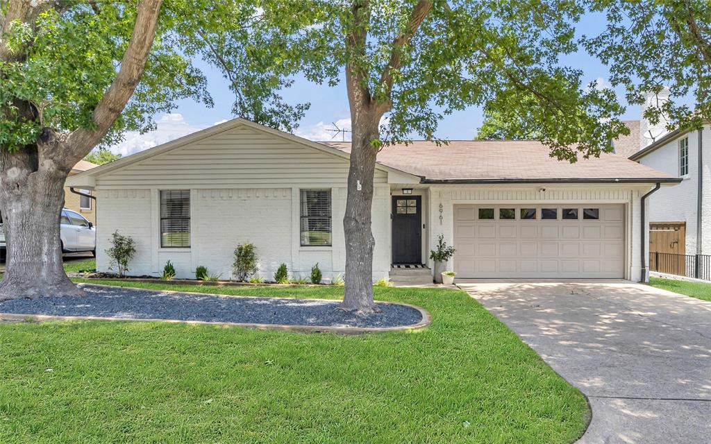 Perfectly positioned just steps from the Santa Fe Trail and minutes to White Rock Lake, this Lakewood Elementary home has been thoughtfully and extensively updated to blend modern comfort with timeless appeal. Inside, you'll find a beautifully renovated interior featuring new wood floors, fresh paint throughout, recessed lighting, and custom closets that maximize storage and organization. The fully updated kitchen and bathrooms showcase high-end finishes and a clean, contemporary aesthetic, while still feeling warm and inviting. The bright and open living room centers around a cozy gas fireplace, creating a perfect spot to unwind. Just off the living room, the dining area features a built-in bar with a wine refrigerator—ideal for hosting gatherings or enjoying a quiet evening at home. The kitchen is a true showpiece, complete with custom inset cabinetry, sleek quartz countertops, and stainless steel appliances, offering both functionality and a designer touch. The spacious primary bedroom includes a generous walk-in closet and a serene ensuite bath with dual sinks and a beautifully tiled walk-in shower. Step outside to a large backyard with a patio, ideal for outdoor entertaining, play, or simply relaxing in your private green space. Exterior upgrades include fresh landscaping, a new wood fence, updated exterior paint and lighting, and an attached two-car garage with additional storage space.  Tucked away on a quiet street in Lakewood, this charming and cozy home is a rare find in a beloved neighborhood—it truly has it all.