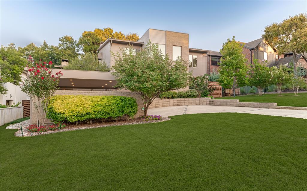 Modern Contemporary on one of Lakewood’s most prestigious streets. The striking sculptural drive-up makes a statement—inside, the spaces reveal a warmth that is elegant and comfortable. Fresh paint highlights the home’s clean lines and modern design, setting the stage for a sophisticated lifestyle. The open-concept floor plan flows seamlessly for entertaining, anchored by a chef’s kitchen with wet bar, quartzite countertops and top-of-the-line appliances. The impressive custom walnut cabinets feature grain matching, adding harmony and balance to the space. Every detail has been designed to impress. Museum-quality walls and soaring ceilings provide the backdrop for art of almost any size. On the lower level, you’ll find a catering kitchen, a media room designed for intimate movie nights and one of two laundry rooms. At the heart of it all is a showstopping, climate-controlled 600-bottle wine library—complete with rolling ladder and views of the pool and lake beyond—designed for the serious collector who loves to entertain and protected by a full-home Generac generator. Floating, glass-railed staircases connect each level, adding understated drama throughout. Almost every room in the home captures a view, with the primary bedroom—located on the main floor—enjoying especially stunning sightlines. The primary bathroom brings the beauty of the outdoors inside with a serene retreat, featuring grain-matched cabinetry and thoughtfully designed closets for everything. Outside is a private retreat: a luxurious pool framed by an expansive Ipe wood deck, freshly stained to complement the architecture. The setting is ideal for relaxing afternoons and lively summer gatherings. Just beyond, White Rock Lake offers beautiful views and easy access to trails, sailing and birdwatching, while the historic fish hatchery is just around the corner—offering a forest at your fingertips accompanied by nature and recreation at your doorstep. This is more than a home—it’s a modern masterpiece.